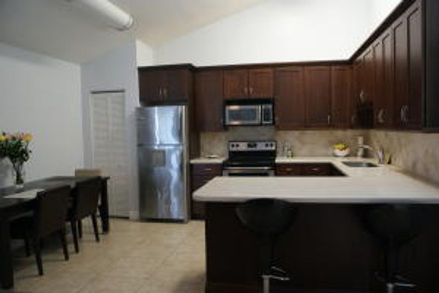 Fantastic 3 bedroom, 2 bath, with private screened in patio located in the desirable community of Westwood Gardens.  This updated split bedroom floor plan home features a renovated kitchen and bathrooms, stainless steel appliances, corian counter tops, tile flooring throughout, and a large great room.  This lovely community includes pools, tennis and basketball courts as well as a clubhouse.  Conveniently located close to I-95, shopping, and wonderful schools, this is a fabulous opportunity to own a beautiful home in a friendly neighborhood.