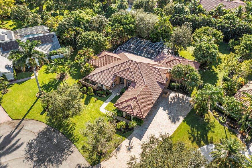 Remodeled 4 Beds/ Bonus Room, 3.5 Bath Pool w/3.5 Car Gara Nearly Acre Lot Cul-De-Sac. Long Travertine Pavered Driveway, Split Floor Plan w/3 Diff Additions Adding 1,000 SqFt Under Living Area! Updated Primary Bath w/Quartz Counters, Separate Tub & Shower! Primary Bed w/Sitting Area/Bonus Room, 2 Walk-In Closets, On-Suite Bed/Cabana Bath, 2 Huge Beds Coral Stone Fireplace/Oversized Fam Room w/Built-In Bar. All Additions Have Impact Windows. 3 Newer A/C Installed In 2015, 2021, & 2022. Stunning Hurricane Rated Screened-In Patio Area Ideal For Entertaining w/Built-In Barbecue, Saltwater Heated Pool w/Spa. Impact Garage Doors Installed In 2015 & 2020, Resort-Style Amenities, 24-Hour Gated, A-Rated Schools & Low HOA Dues!