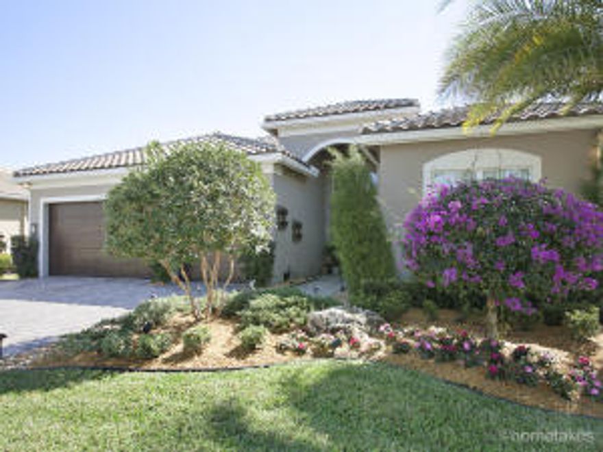 Immaculate, exquisitely decorated home has been barely lived in. It promises to receive oohs & ahhs...Each bedroom a Suite. Wood floors, orange-peel wall finish, custom after-market kitchen w/ island, wine fridge, quartz counters & porcelain sink, Bosch D/W, under/over-cabinet lights, upgraded roof tile, burglar/fire/smoke/CO system, extensive landscaping w/dramatic lighting, designer light fixtures & recessed lighting, custom paint colors, full impact glass, solid wood doors w/applied moulding, ceiling fans, upgraded front-load washer & dryer, laundry cabinetry, private backyard, 3-car garage w/ceiling fans & fridge, patio ceiling fan, plantation shutters, outdoor shower, pool pre-wire, gas BBQ, fire pit & patio furniture included. One- time capital contribution of $749 at closing.