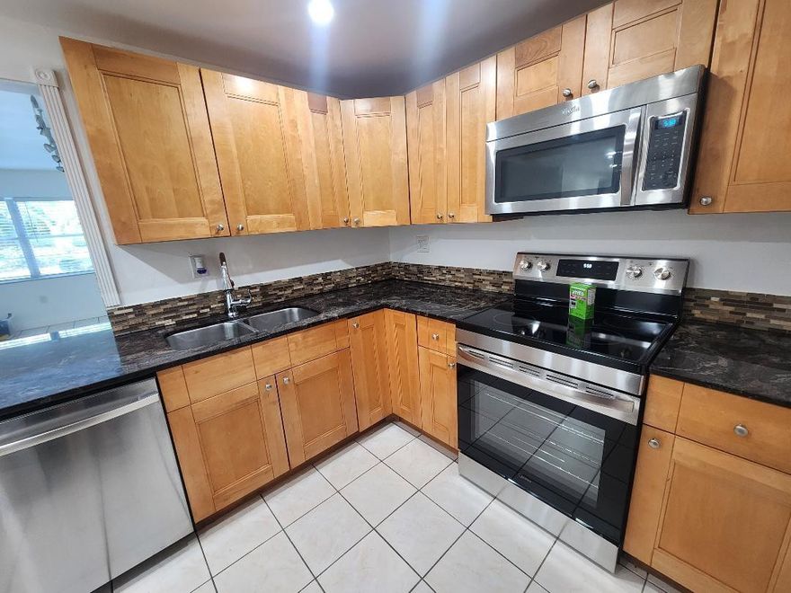 Exceptional opportunity for INVESTORS. Unit can be rented INMMEDIATELY. Impeccable, spacious 1st floor corner unit, 2-beds, 2-baths ready to deliver strong returns. Last rented for $1,980/mon. Kitchen remodeled w/granite countertop, stainless-steel appliances, new range & A/C Unit installed in Aug 2025. Updated baths w/new vanities, master w/double sink & soft close. New LED lighting w/dimmers, new waterproof laminate flooring in bedrooms, remote-control fans, new tankless water heater & Screened Balcony. Access to this first-floor apartment directly from the parking lot. Small pets are allowed. Access to Clubhouse and pool. The community laundry room is steps away. Near major highways, including I-95, Turnpike, & beaches. Perfect for investors looking for immediate cash flow.