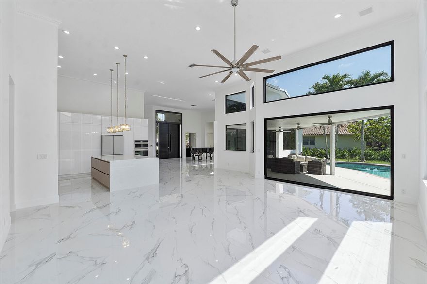 Situated within Palm Island's esteemed guard-gated community, this luxurious residence features 5 bedrooms and 3 FULL bathrooms. Experience luxury living in this meticulously maintained home .The triple split layout ensures maximum privacy, making it perfect for families or for guests. The high ceilings and entryways throughout the home add to the grandeur and elegance of the space. Natural light throughout home creating warm atmosphere. Brand NEW KITCHEN Upscale European design and features, BRAND NEW European style doors throughout , BRAND NEW CLOSESTS  , BRAND NEW HIGH IMPACT WINDOWS & DOORS throughout, great sized pool perfect for South Florida summer days. Circular Driveway and featuring a 2 car garage. New Solar Panels !! Make this paradise living your new home!!!!