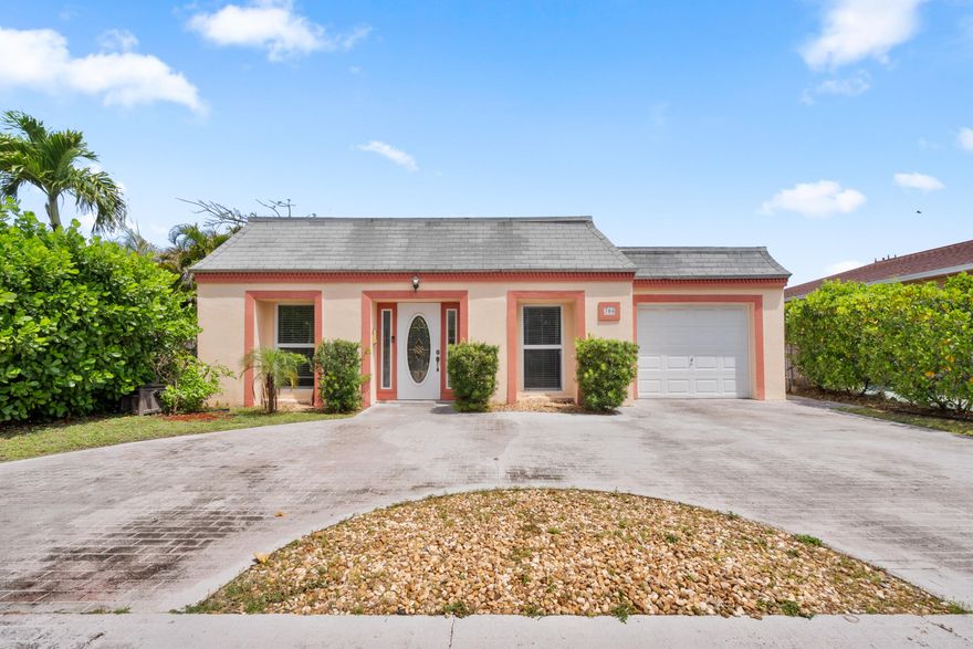 Welcome to this stunning 3-bedroom, 2-bathroom home in the heart of Lake Worth Beach! Offering over 2,100 sq ft of well-maintained living space, this CBS single-family home is a true gem. Ideally located near the Intracoastal, it features spacious rooms and a generous yard perfect for enjoying the Florida lifestyle. Inside, you'll find an updated open kitchen with granite countertops, neutral tile flooring throughout the main living areas, custom mirrored accents, elegant French doors, ample closet space, and a convenient indoor laundry room. Major updates include a NEW A/C, hot water heater and washer and dryer. The exterior offers a circular driveway, one-car garage, impact windows, fenced in yard and a covered, screened patio. Come see what Lake Worth Beach is all about!