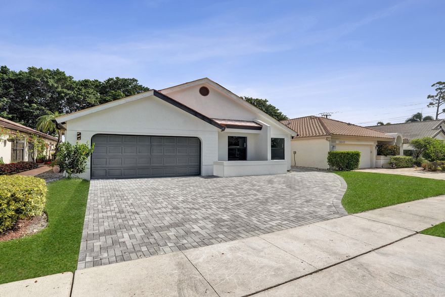 Welcome to this stunning fully renovated 3-bedroom, 2-bathroom residence located within the prestigious Boca Woods Country Club. Designed with a modern open-concept floor plan, this exceptional home offers luxurious living with top-of-the-line finishes and upgrades throughout. Features include a new metal roof, hurricane-impact windows and doors, new A/C system with updated ductwork, and a commercial-grade epoxy garage floor combining style and durability. The beautifully redesigned kitchen is equipped with premium Samsung appliances, including a double oven and microwave combo, cooktop, and a sophisticated wine bar perfect for entertaining. Step outside to your private backyard oasis featuring a newly renovated pool, elegant tumbled marble patio, new pool equipment, and pool heater. Experience resort-style living in one of the most sought-after private club communities in Palm Beach County. Boca Woods offers: Championship golf Private pickleball and tennis courts State-of-the-art fitness center Fine dining and vibrant social activities This gated country club community is known for its welcoming atmosphere, active lifestyle, and beautifully maintained surroundings.    Mandatory membership required with a one-time initiation fee of $150,000. Details available upon request. Don't miss this incredible opportunity to own a move-in-ready luxury home in the heart of Boca Raton