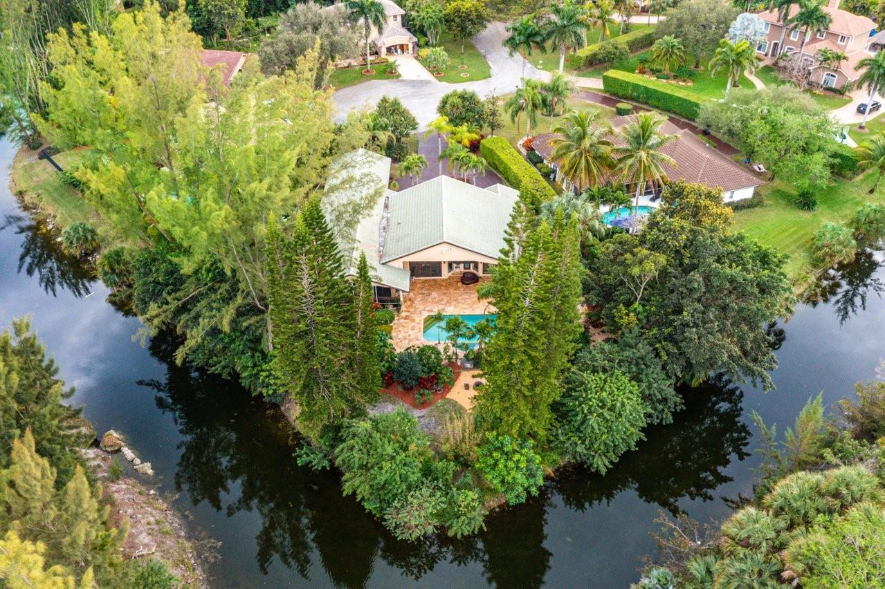 Simply a beautiful home within a stunning setting & on a waterfront point lot. Water & protected preserves surround the home on several sides providing privacy & breathtaking outdoor spaces. Impressive interior updated with ultra-fine finishes! Exotic stones, natural materials, & organic textures brilliantly commingle with state-of-the-art technology. Fabulous kitchen/family room area with a fireplace surrounded by impact glass doors that open to the pool area allowing for seamless indoor/outdoor living. Highlights: Soundproof Theater Room/Savant whole home automation/28 camera security system/Bisazza hand-blown glass tile/Lutron blinds/New tankless water heater/Impact windows & doors/Resort-style pool with spa & sunning shelf/Sublime primary suite/ 200 ft of water frontage