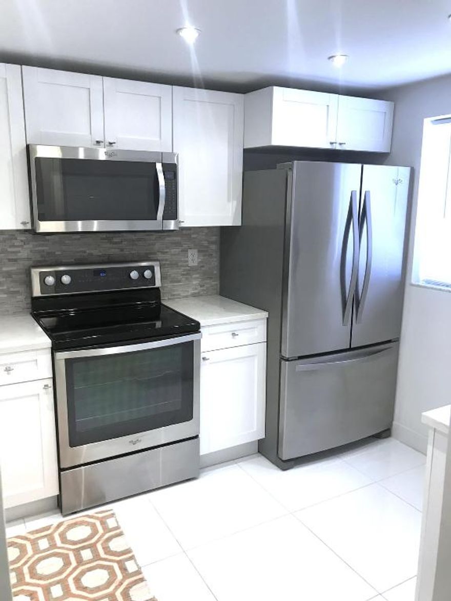 Welcome to Boca Cove! Gated Community. This Beautiful remodeled unit has a 2 bedrooms & 2 Baths, all porcelain floors, wood cabinets, Quartz countertops, stainless steel appliances, frameless glass shower doors, impact windows, washer & dryer, private enclosed patio. The condo is located on the first floor with 1 assigned parking space.