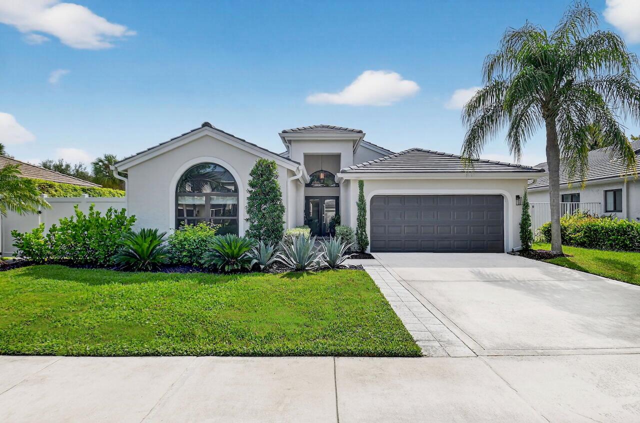 This inviting single-level home has nearly 2,000sf with 3 beds/2 baths and an open concept living area. Enjoy long water views through the great room windows with lush landscaping surrounding the home to create a tropical oasis. The kitchen is the heart of the home with modern, open-concept central island, SS appliances, and sleek finishes. Enjoy the 2024 ROOF and IMPACT GLASS WINDOWS and DOORS, oversized porcelain flooring, modern interior doors and trim, and custom built-in closets throughout. Extra perks include fresh landscaping and paint, a newer water heater, and a Trane A/C system. A full home water filtration system, custom window treatments, a white 6' privacy fence adjacent to the easy-access community pool, plus privacy tinting on the hurricane impact glass front door.