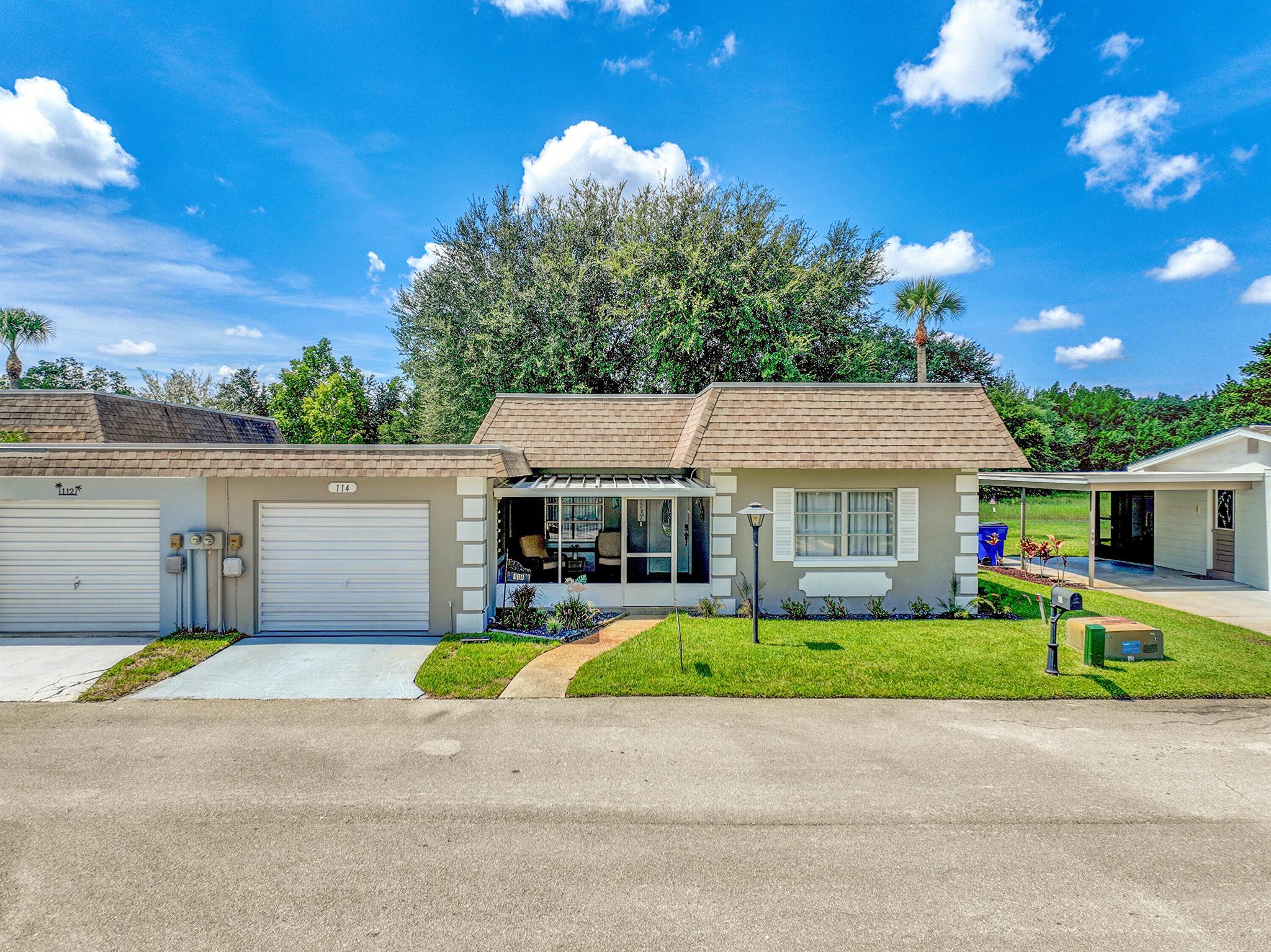 This beautifully remodeled 2/2 villa offers just under 1300 square feet of living space. It features a Florida room and two outdoor sitting areas. The front entryway is screened in and offers views to Lake Grassy. The back patio is great for entertaining & outdoor dining. This property is wonderful to live in year round, but can also be used as an investment. It is currently being used as an Airbnb. Offering a low monthly HOA with very few restrictions. Located close to Lake Grassy, shopping, doctors offices, and restaurants!