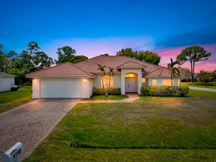 Welcome to this beautifully upgraded 4-bedroom, 3-bathroom CBS Royal Wall home situated on an oversized corner lot in Port St. Lucie. Offering 2,354 square feet of living space, this love-in-ready home combines durability, efficiency, and comfort—with NO HOA restrictions. Built with the upgraded Royal Wall CBS system (up to 3x stronger than standard CBS and more energy efficient), this home features tile flooring throughout, crown molding, and elegant tray ceilings in the spacious primary suite. The primary bedroom also includes his-and-hers walk-in closets and a luxurious bathroom with a soaking tub and bidet. The open living spaces flow seamlessly to a tiled back porch overlooking a canal, providing added privacy and the perfect spot for relaxing or fishing.  The home also includes a paver driveway, 2-car garage, and a new A/C system installed in 2024.A unique highlight is the 4th bedroom with a private hallway, bathroom, and separate exterior entrance, ideal for guests, extended family, or potential in-law accommodations. This home comes fully furnished and includes stainless-steel appliances plus a pedestal washer and dryer, making it truly move-in ready. Conveniently located with quick access to I-95 and the Florida Turnpike, and just minutes from outdoor recreation at Woodland Trails Park and Peacock Park, where you'll enjoy playgrounds, walking trails, kayaking, fishing, and more.