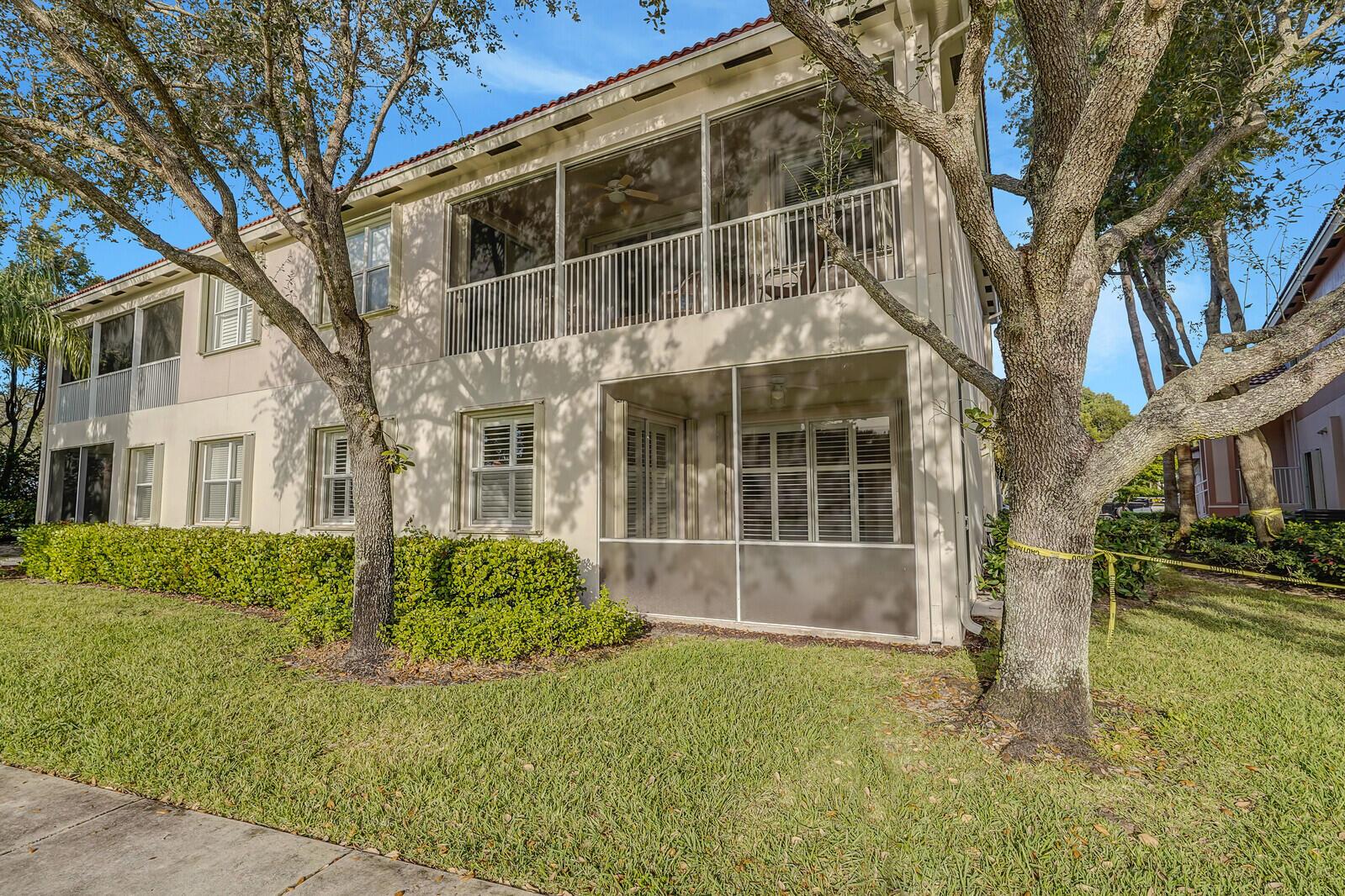 Beautiful upgraded lakefront home! This immaculate, FIRST-FLOOR, 3-bedroom, 2-bath carriage home boasts a bright and open layout. Enjoy the convenience of an attached garage and a screened, tiled lanai with a charming lake view. The end unit offers a private covered entry and features accordion storm shutters for added security. The home is equipped with new stainless-steel appliances, a new air conditioner, upgraded counters, 42'' maple cabinets, and 10-foot ceilings. Decorative crown molding adds a touch of elegance, while upgraded wood flooring spans throughout, highlighting the amazing water views. Beautiful plantation shutters! Situated in a well-maintained gated community in the heart of Wellington, this residence provides access to a pool, gym, card room, and community room.