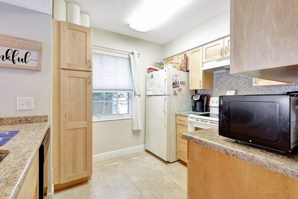 Photo of 1050 Lake Shore Drive #204, Lake Park, FL 33403 (MLS # R11163912)