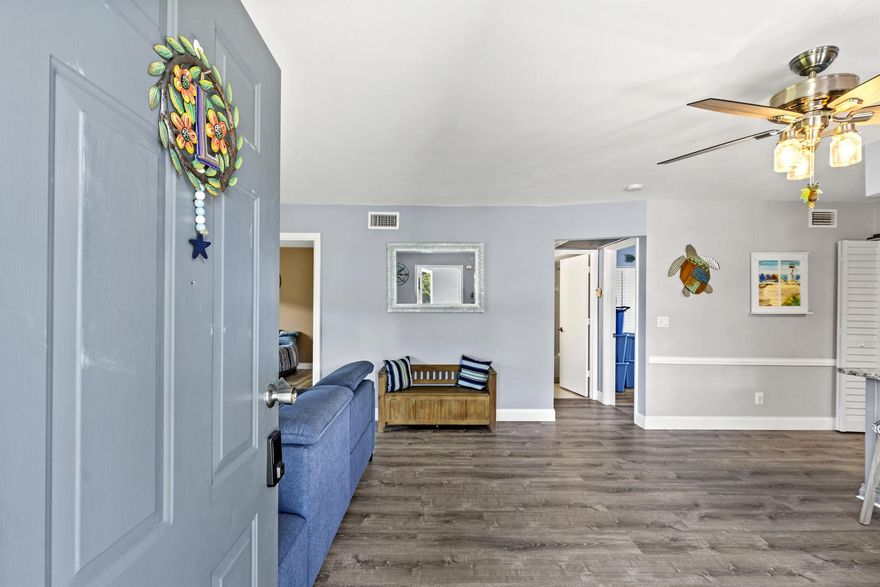 Come check out this completely remodeled GROUND FLOOR unit featuring a 2018 METAL roof, aluminum siding, in-unit washer and dryer, and COVERED carport area and all within walking distance to the POOL and clubhouse! Upgrades galore! No popcorn ceilings, new paint, LUXury vinyl plank flooring, granite countertops, custom kitchen cabinets with pullouts, USB outlets, new deep sink, and under-sink water filtration. Bathrooms boast tiled showers and Bluetooth audio/light systems. New closet and ceiling fans. Cabana from the primary leads to Relaxation on the screened patio with roll down shutters. The Fountains community is a 2 story low rise condo community surrounded by mature trees and landscaping conveniently located next to shopping, and just minutes to the beach!