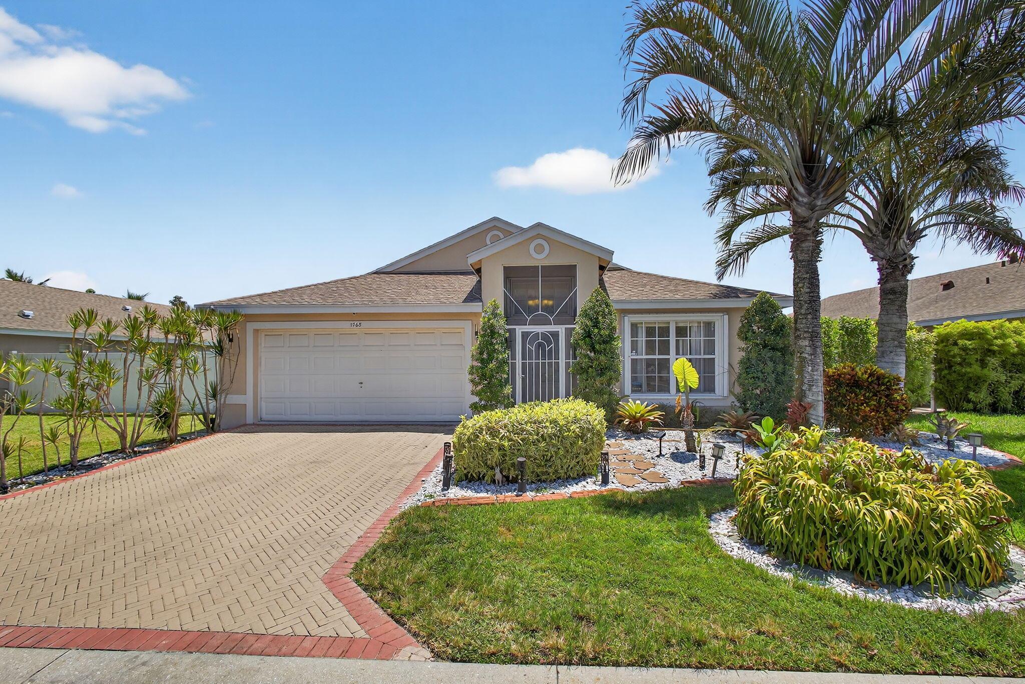 BRAND NEW ROOF 2024!! Stunning lakefront home with 3 bedrooms, 2 baths, a 2-car garage, screened-in pool and spa, and low HOA fee. This move-in-ready property features tile floors throughout the main living areas, custom built closet, vaulted ceilings and recessed lighting. The kitchen and living areas are enhanced with incredible stone accents and decorative backsplashes. The luxurious primary suite boasts a fully renovated bath with floor-to-ceiling porcelain tile, an oversized soaking tub, and elegant finishes. Enjoy your very own tropical oasis through the fenced-in pool and spa surrounded by a serene lake view and mature fruit trees. The heated pool includes a newer pool pump (2023). Full hurricane protection throughout of shutters and hurricane glass