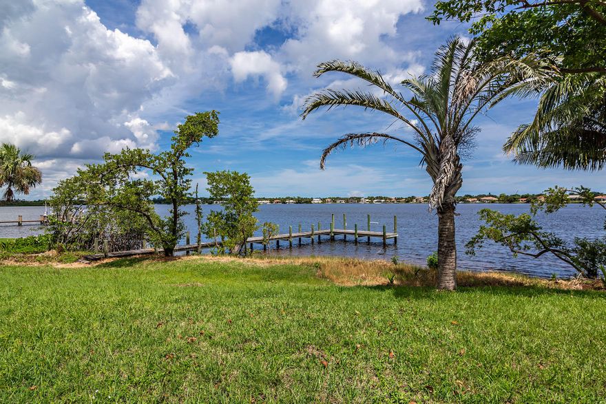 2+ Acre Loxahatchee River Lot! Build your custom dream home on this wooded, riverfront lot offering 150' of frontage, dock, and wide water views. Generous lot size leaves ample room for potential amenities such as tennis court, guest house, or training center. Great location for water sports and just a short boat ride to the ocean and inter-coastal waterway for an array of amazing restaurants.  Make sure to view the aerial video footage under ''virtual tour''.