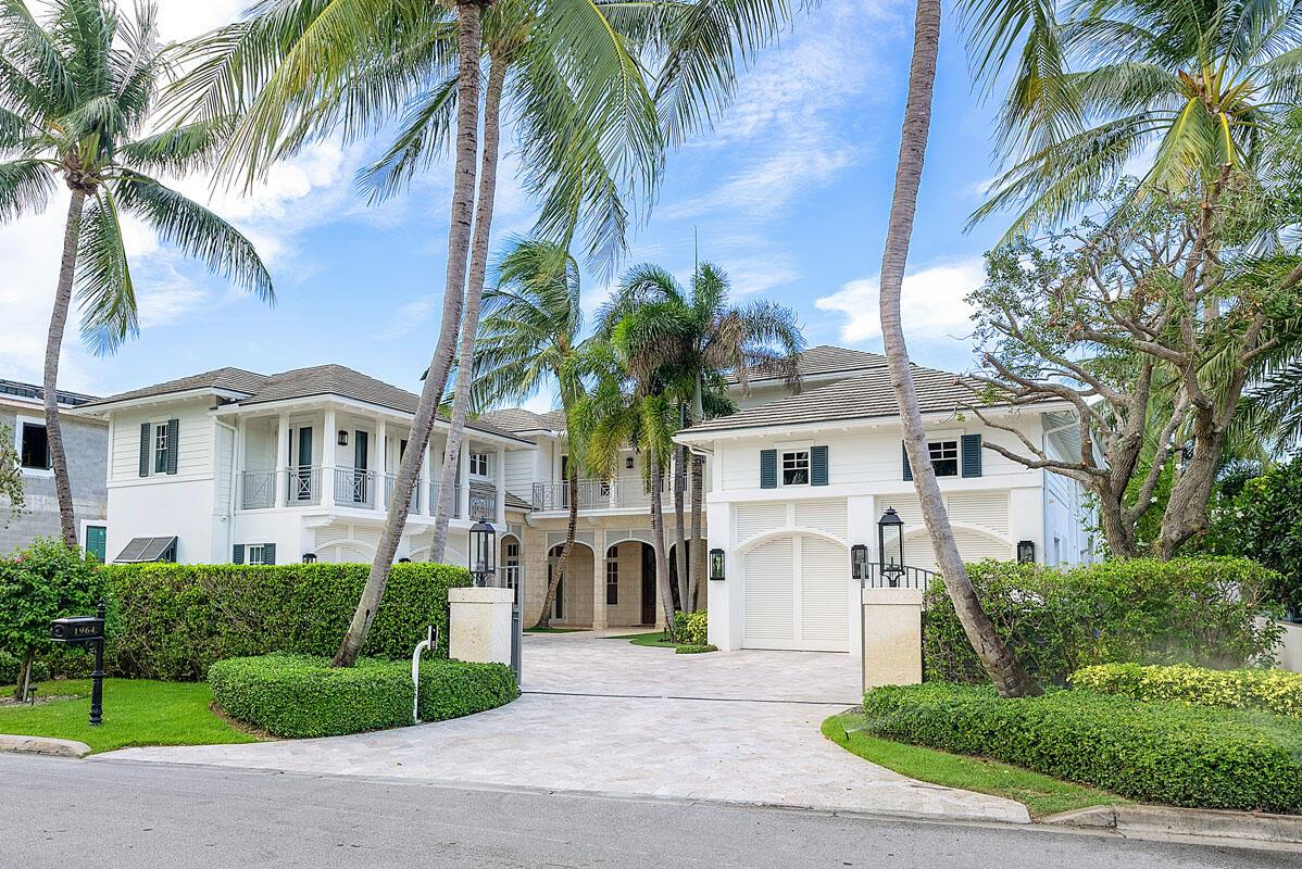 Welcome to 1964 Royal Palm Way, an exquisite estate on an oversized Intracoastal property, offering an impressive 100' water frontage within the prestigious Royal Palm Yacht & Country Club. This exceptional British West Indies home is a one-of-a-kind paradise spanning over 10,000 square feet of luxurious living space. The opulent interior boasts beautiful marble and Brazilian hardwood floors, exquisitely crafted woodwork, six bedrooms suites, and thoughtfully designed custom architectural features that exemplify sophistication and attention to detail. Step outside to your resort-like oasis in the backyard, a haven of relaxation and entertainment. The heated freestyle infinity-edge pool beckons with its enticing design, accompanied by a massive spa, water sprays, and a sun shelf...