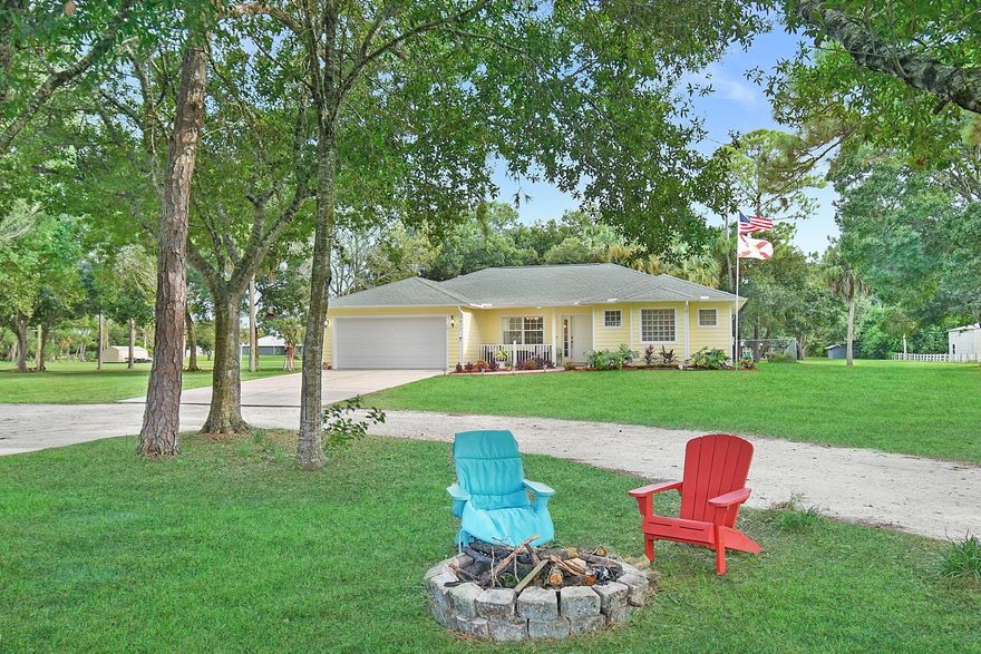 Gorgeous Pool Home on 2 acres in West Ft. Pierce = Paradise! As you drive up the long driveway under the canopy of trees, you'll arrive to see that this 3BR, 2BA beauty offers 2,000 sq ft under air and a split floor plan that provides space and comfort alike. Once inside, you'll find that the gourmet kitchen features granite countertops, all stainless-steel appliances, and that it overlooks the family room and pool area. Imagine stepping outside to enjoy a refreshing dip in the pool on a warm summer day. And when ''winter'' arrives, cozy up around the fire pit beneath a star-filled sky. This spacious property is a rare blend of country charm and convenience--close to town yet away from the rat race. It's the perfect place to relax, gather, and create memories that will last generations!