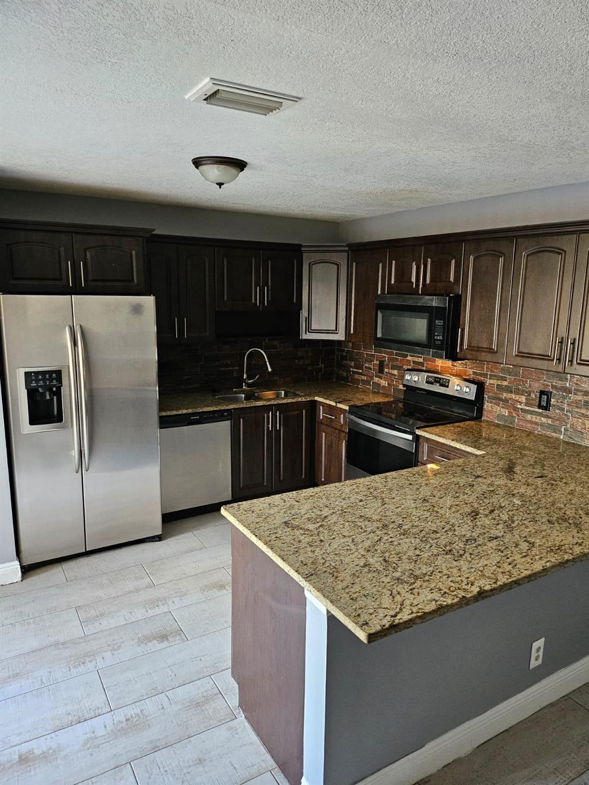 Beautiful 2/2.5 townhouse in the heart of Wellington. Spacious and open floor plan with a private fenced and courtyard which provides plenty room to roam. Tile and laminate floor throughout entire home. Upgraded kitchen with granite countertops and stainless steel appliances. Newer A/C and all bathrooms have been updated too. Both bedrooms have their own bathroom on 2nd floor and walk-in closet. Balcony is off master bedroom overlooking the courtyard. Great location, close to shopping, park, and Wellington Green Mall. Come see this fabulous home before it's gone!