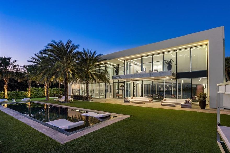 Enjoy Life in this Contemporary Palm Beach Waterfront Estate Home!
This incredible 5,076 SF home in a very private setting is perfect for the upscale owner who wants only the best of everything. Located on over a ½ acre lot the main home has 4 bedrooms and 4 fulls baths for family living, a fabulous open floor plan for entertaining and a large guest house (2 bedroom/2 bath) w/ its own entrance.
Among the truly unique features are the walls of glass that provide natural light throughout every room, a cozy fireplace in the large living room, a den/office and southern water views from virtually every room.   The gourmet kitchen offers spectacular water views, a center-island prep area with breakfast bar for in-kitchen dining, state of the art appliances, custom countertops and cabinet Use the built-in elevator or take the unique wooden staircase to the second floor where you'll find the large master suite with walk-in closet, and the master bath. Both rooms feature breathtaking views of the water through walls of glass overlooking the patio, the infinity edge pool and Intracoastal waters.

A guest house with separate entrance offers 2 bedrooms and 2 baths, living room and kitchen. It's perfect for visitors, or as a mother-in-law suite. It too features glass walls and eye-pleasing views for the property.
 
For the sailor or yachtsman, this point-lot property includes 315' of total water frontage on 2 sides, a private dock with a 6,000-lb boat lift on the east side of the property.  You'll enjoy navigable waters along the Intracoastal to direct Ocean access just minutes away.
 
Other amenities include impact glass walls and windows throughout the home, the provision for a whole house generator, custom lighting and an attached 3-car garage.
 
Living in Palm Beach places you in one of the most exclusive towns in America. You're close to some of the finest golf courses in the country, as well as dining and shopping in world renowned restaurants and shops and two nearby international airports. If the best life has to offer is what you want with a waterfront lifestyle in the lap of luxury, this Palm Beach waterfront home is for you.