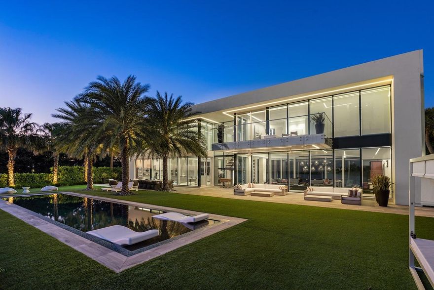 Enjoy Life in this Contemporary Palm Beach Waterfront Estate Home!
This incredible 5,076 SF home in a very private setting is perfect for the upscale owner who wants only the best of everything. Located on over a ½ acre lot the main home has 4 bedrooms and 4 fulls baths for family living, a fabulous open floor plan for entertaining and a large guest house (2 bedroom/2 bath) w/ its own entrance.
Among the truly unique features are the walls of glass that provide natural light throughout every room, a cozy fireplace in the large living room, a den/office and southern water views from virtually every room.   The gourmet kitchen offers spectacular water views, a center-island prep area with breakfast bar for in-kitchen dining, state of the art appliances, custom countertops and cabinet Use the built-in elevator or take the unique wooden staircase to the second floor where you'll find the large master suite with walk-in closet, and the master bath. Both rooms feature breathtaking views of the water through walls of glass overlooking the patio, the infinity edge pool and Intracoastal waters.

A guest house with separate entrance offers 2 bedrooms and 2 baths, living room and kitchen. It's perfect for visitors, or as a mother-in-law suite. It too features glass walls and eye-pleasing views for the property.
 
For the sailor or yachtsman, this point-lot property includes 315' of total water frontage on 2 sides, a private dock with a 6,000-lb boat lift on the east side of the property.  You'll enjoy navigable waters along the Intracoastal to direct Ocean access just minutes away.
 
Other amenities include impact glass walls and windows throughout the home, the provision for a whole house generator, custom lighting and an attached 3-car garage.
 
Living in Palm Beach places you in one of the most exclusive towns in America. You're close to some of the finest golf courses in the country, as well as dining and shopping in world renowned restaurants and shops and two nearby international airports. If the best life has to offer is what you want with a waterfront lifestyle in the lap of luxury, this Palm Beach waterfront home is for you.