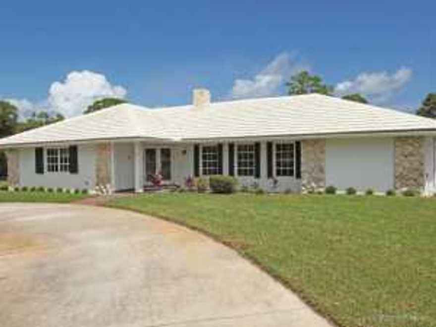 Pristine CBS 3/3 with split floor plan and lovely golf views. Large lot on quiet street with circular drive. Beautiful double front doors with etched glass welcome you as you enter the home. Two sided fireplace adds charming ambience to the living and family rooms. Upgrades include laminate wood flooring in the living room (2011), new kitchen with wood cabinets, granite, and stainless steel appliances (2011), water heater replaced in 2011, pool pump replaced in 2012 , roof replaced in 2003, and electrical box replaced in 2012. Large enclosed pool, full house generator and hurricane shutters make this a winner to the most particular buyer. There is nothing left to do but move in.No HOA application required for sale/lease.