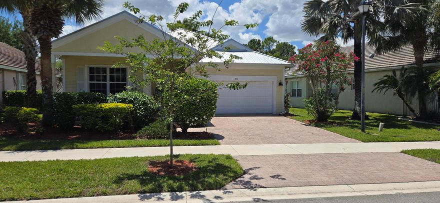 Welcome to 195 NW Willow Grove Avenue. As you approach this Key West style home, you are greeted with a cheerful yellow exterior, accented by Hardie board siding, decorative shutters, and a spacious covered front porch. With 3 bedrooms, 2 bathrooms, formal dining room, family room, breakfast nook, and screened-in lanai, there is plenty of places for the family to gather. The light and bright kitchen boasts 42-inch cabinets, decorative backsplash, pantry, eat-in bar, and breakfast nook. The primary suite has tray ceilings, room for a sitting area, 2 large closets, and an ensuite bathroom with a soaking tub, separate shower, and dual vanities. New metal roof 2026, AC 2022 , Hot water 2021, new carpets in 2 bedrooms, and a new floor in primary bathroom.