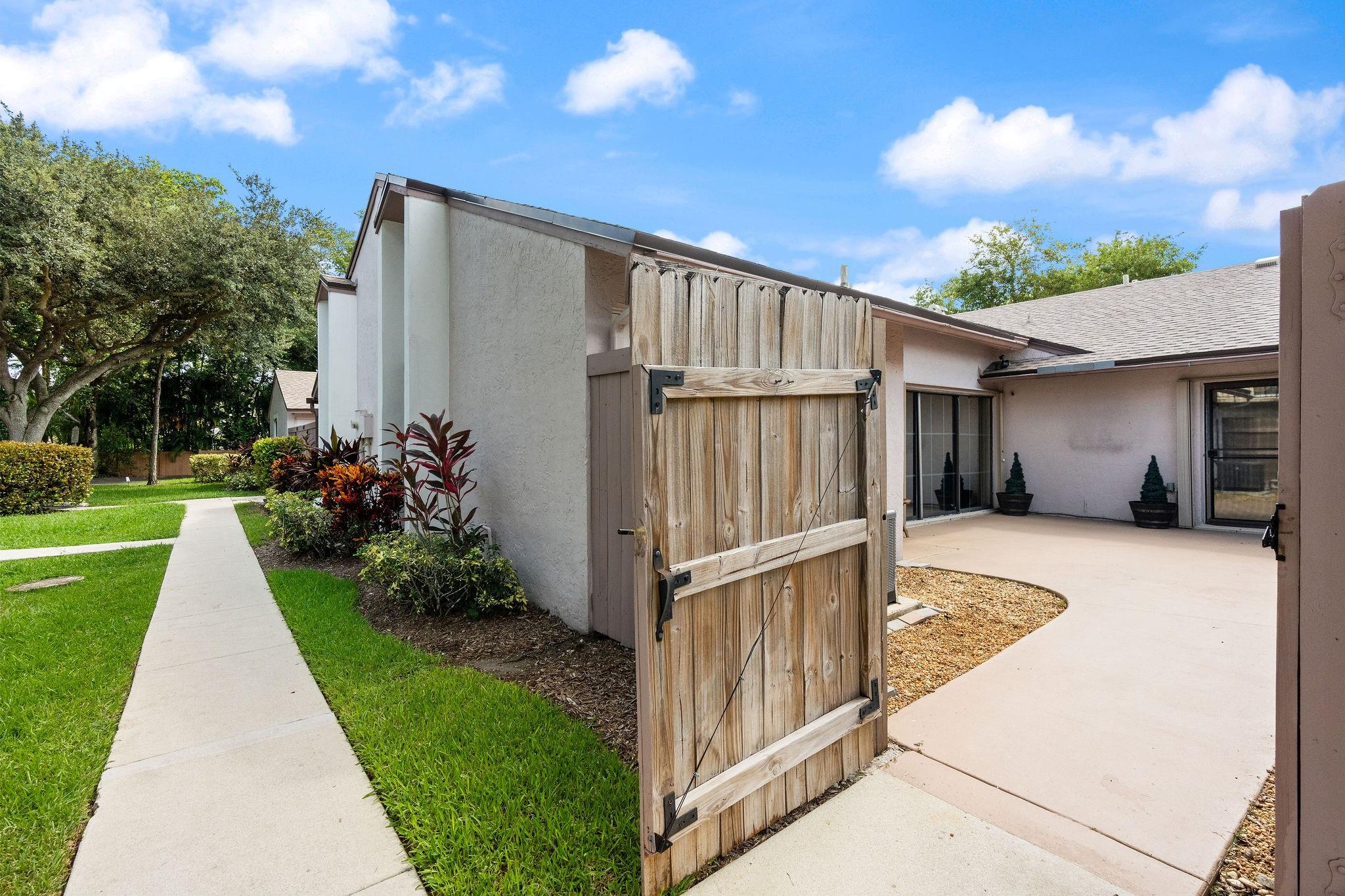 ***WELCOME TO THE COURTYARDS OF PLANTATION!!!***BEAUTIFULLY UPGRADED 2 BEDROOM, 2 BATHROOM VILLA IN THIS EXCLUSIVE NEIGHBORHOOD! THE OPEN FLOOR PLAN WITH ABUNDANT NATURAL LIGHT GREETS YOU AS YOU ENTER AND VAULTED CEILINGS PITCHED UP TO 11-FT AWAIT. BEAUTIFUL GOURMET KITCHEN WITH WOOD CABINETS, GRANITE, NEWER SS APPLIANCES! NEW WOOD-LOOK PORCELAIN TILE THROUGHOUT THE ENTIRE HOME. THE SPACIOUS PRIMARY SUITE IS COMPLETE WITH A WALK-IN CLOSET AND AN UPGRADED BATHROOM. ENJOY PRIVATE FENCED PATIO TO RELAX & ENTERTAIN (PAINTED 2025)! NEW ROOF (2019), AC (2023), DISHWASHER (2024), TANKLESS WATER HEATER, FULL ACCORDION SHUTTERS, EXTRA STORAGE, AND 2 PARKING SPACES. HOA COVERS ROOF, LAWN, TRASH, & POOL. HOME IS FHA APPROVED AND QUALIFIES FOR ASSUMABLE 4.5% FHA LOAN!--CALL FOR DETAILS!