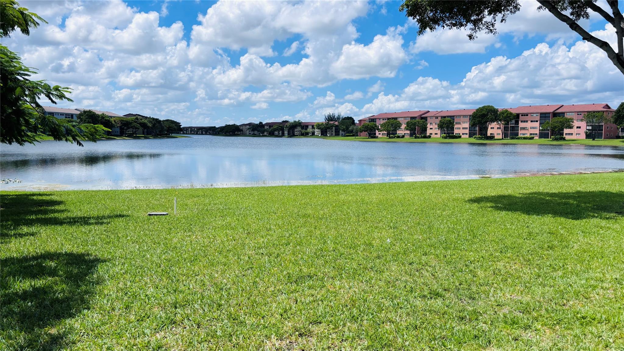 Enjoy breathtaking lake views stretching half a mile from this spacious 1 bedroom, 1.5 baths, on the 4th floor condo located on the newest side of a vibrant 55+ community. This unit features an eat-in kitchen, large living areas, a generously sized bedroom with a walk-in closet, and the convenience of an in-unit washer and dryer. Perfectly situated near the elevator, it offers both comfort and accessibility. The community is rich in amenities, including pools, tennis courts, clubhouse, theater, and 24/7 security patrols, ensuring both recreation and peace of mind. Water, basic cable, and internet are included in the association fees, making living here effortless and enjoyable. 1 person must be 55 or older. Courtesy transportation for residents.