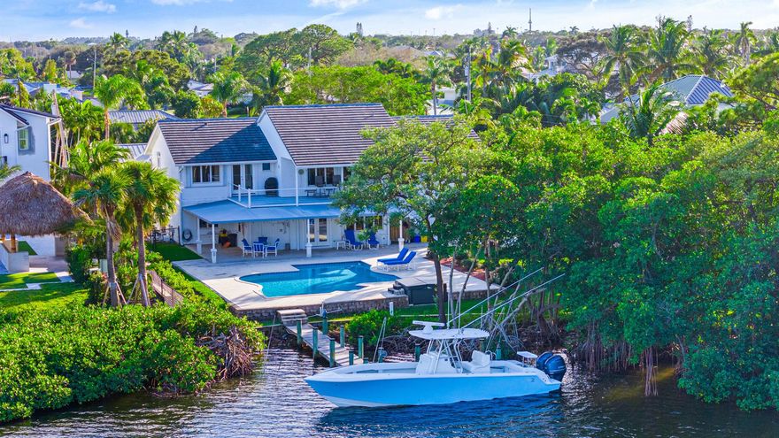 Tucked away in the heart of Jupiter is 965 Marlin Drive offers that rare mix of peaceful seclusion and big water views of the turquoise water that give you direct access to the very best of our coastal lifestyle. With nearly half an acre along a quiet cove off the Intracoastal, this property is a slice of old Jupiter--where time slows down and the water is always calling. Cruise the sandbar, hope on the boat and grab lunch at a favorite local dockside spot, or head out the Jupiter Inlet for a day on the ocean. Whether it's boating, paddleboarding, or simply watching the manatees glide by, life here is meant to be lived outdoors.You're just minutes to the Loxahatchee River, Jupiter Inlet, and some of the area's most scenic natural beauty. And when