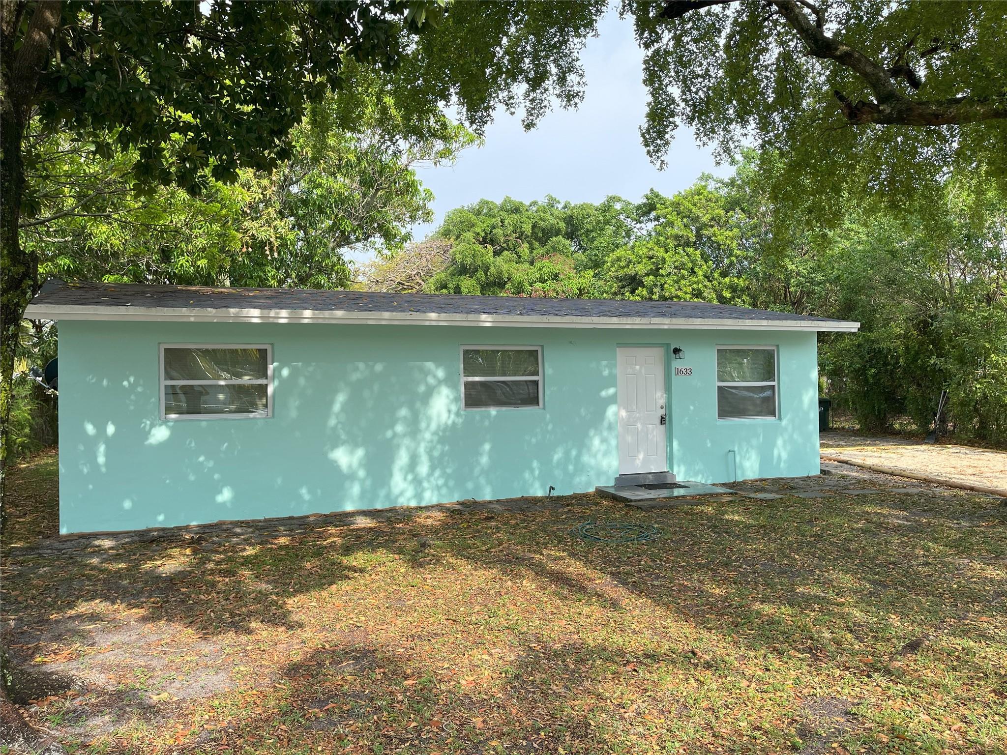 Charming 3-bedroom, 1-bath home with a spacious, fully fenced yard on a peaceful street. Features a completely remodeled kitchen with modern cabinets, sink, and appliances. Includes a large central living area and a separate laundry room with washer and dryer hookups, along with ample storage space. The backyard is expansive, boasting mature fruit trees and plenty of shade. Conveniently located near downtown Fort Lauderdale for work, entertainment, and dining, with easy access to I-95, I-595, and Route 1. Quick application and approval process. No pets allowed. No HOA approval required.