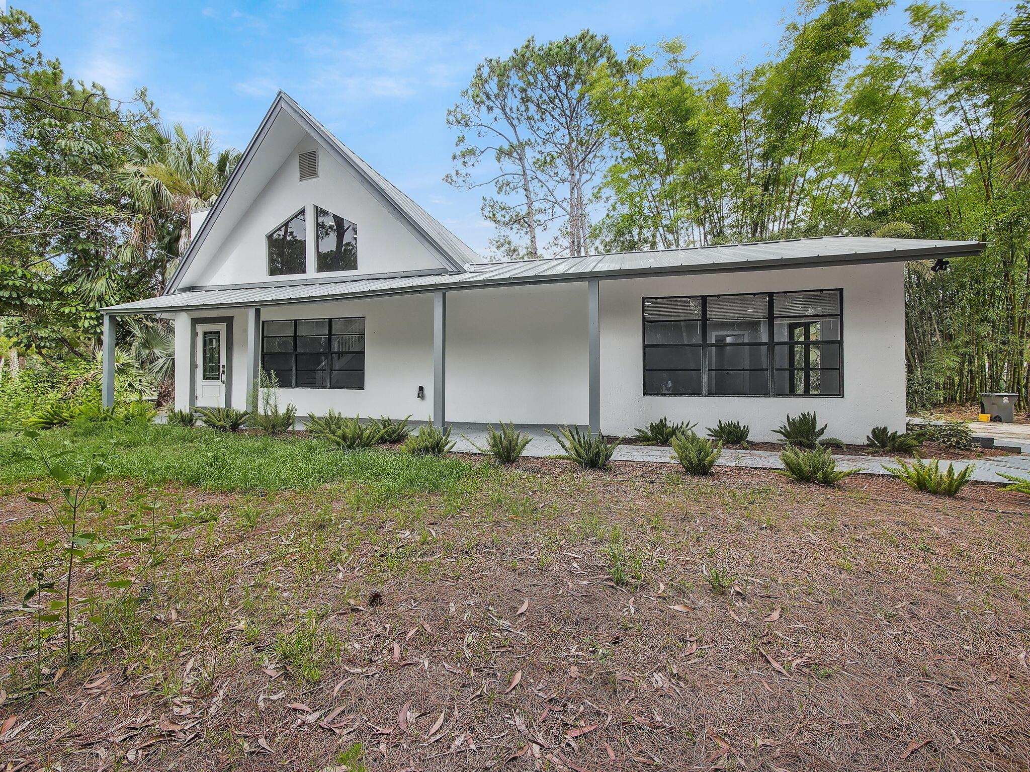 Discover privacy, space, and modern living in this beautifully renovated 4-bedroom, 3-bathroom home nestled on 1.2 lush acres with mature trees, a private pond, and a brand-new metal roof. This move-in-ready residence offers comfort, style, and top-of-the-line upgrades in a serene setting--perfect for those seeking both relaxation and convenience.Behind the gated entrance and along the extended concrete driveway, you'll find a fully updated home featuring luxury vinyl plank flooring, recessed lighting, and an abundance of natural light throughout. Enjoy peace of mind with a new 5-ton AC unit, tankless water heater, new full-size washer and dryer, and a whole-home water filtration system.The spacious, open-concept layout flows effortlessly from the living area to the chef's kitchen,