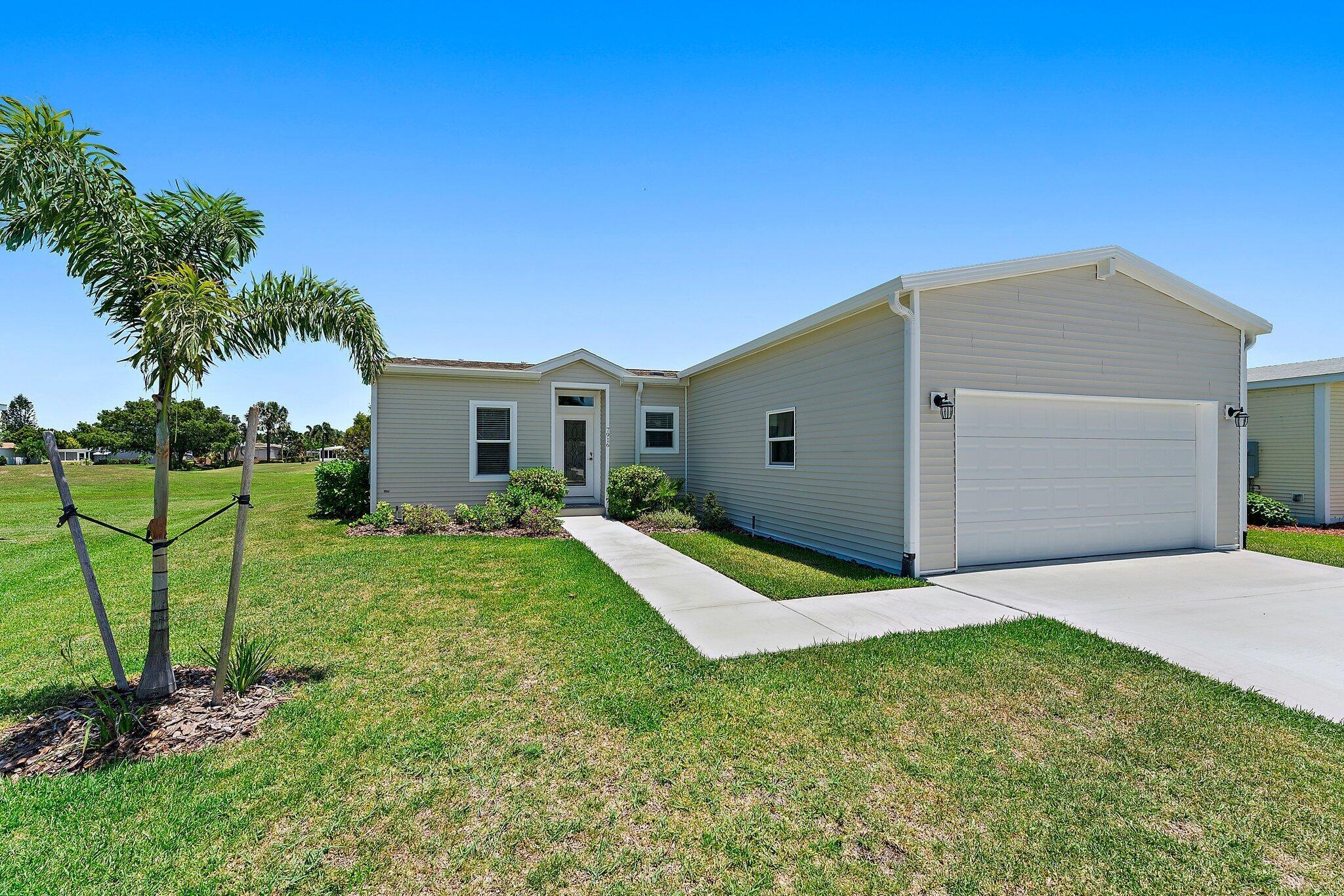 Welcome to your luxurious oasis in the heart of the exclusive 55+ community of Savanna Club. This stunning NEW 2023 Palm Harbor built home offers the epitome of modern comfort and elegance. Step into the spacious open great room floor plan, adorned with SHAW luxury vinyl flooring that exudes both warmth and durability. The kitchen is a chef's delight, featuring a sleek quartz island complemented by white shaker styled cabinets, SS appliances, and LED lighting for a contemporary touch. Relax in the serenity of your screened lanai, and enjoy with golf views and Eastern breezes. The home boasts a desirable split plan layout, providing privacy between the primary suite and the guest bedroom and den. Both bathrooms are appointed with stylish tile and fixtures. Land Lease Property