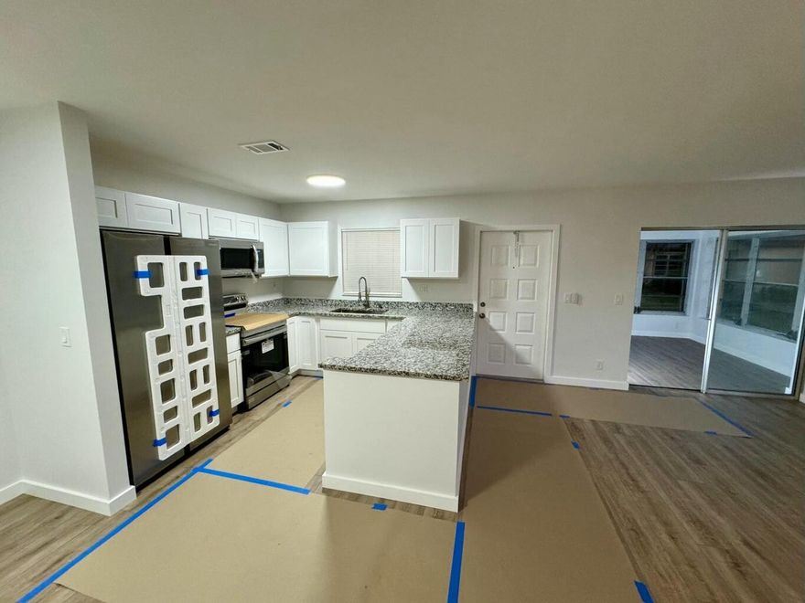 No Age Restrictions.  Completely Renovated End-Unit Condo Move in Ready...Beautifully updated offers modern comfort...Featuring spacious open living and dining area that leads to enclosed porch/sunroom.  2 large bedrooms and 2 full bathrooms renovated with sleek digital, warming mirrors, New ceiling fans, New kitchen disposal., New premium granite countertops, new flooring, New closet doors, New Glass shower doors, New Toilets, no carpeting. A Must See.