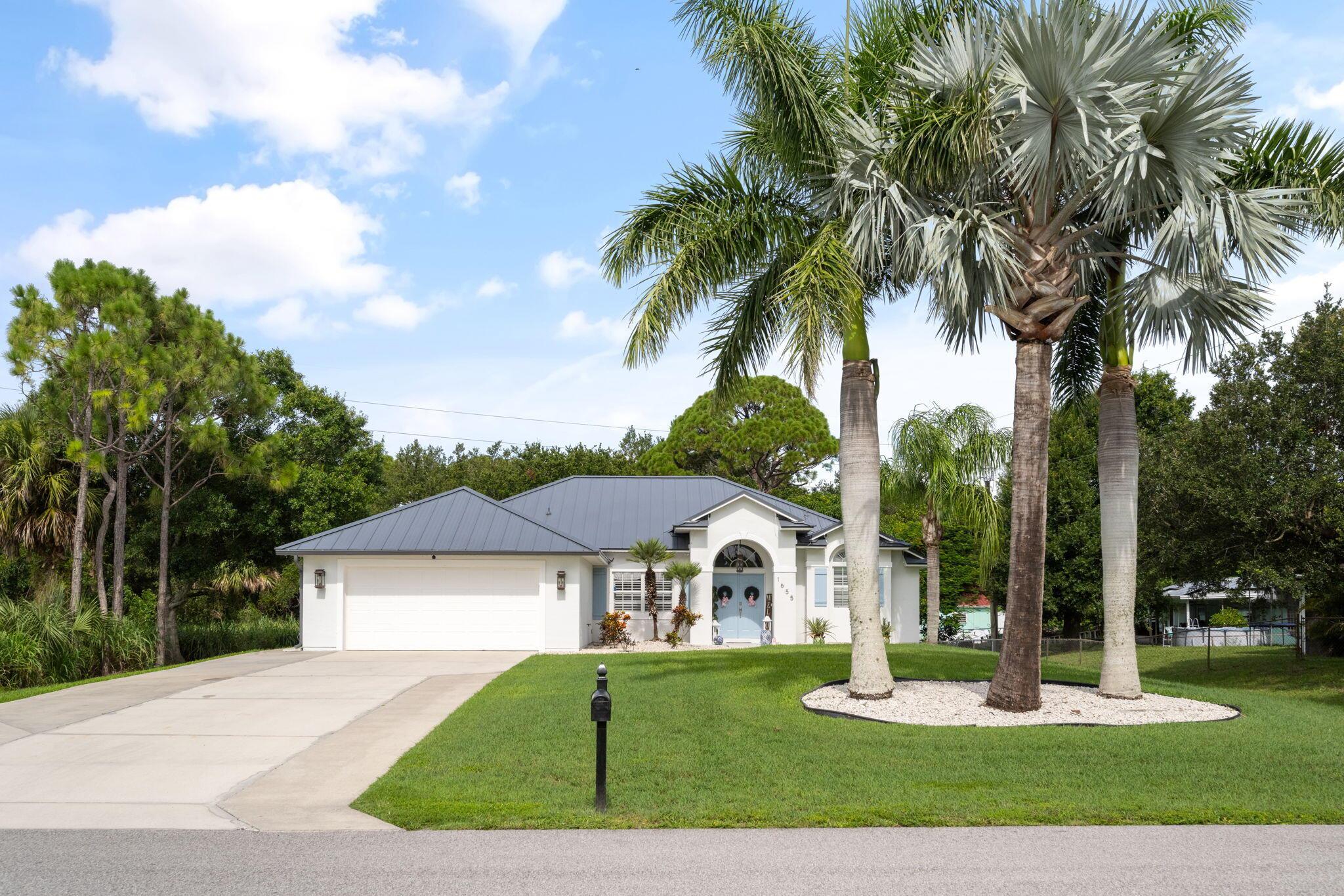 This beautifully updated home sits on nearly 1/2 acre & offers the perfect blend of modern charm & comfort. Featuring a newer metal roof, this bright, open-concept 3/2/2 boasts vaulted ceilings, LVP flooring, plantation shutters, & a crisp coastal color palette. The kitchen shines w/white shaker cabinets, quartz counters, a statement backsplash, & SS appliances. Enjoy seamless indoor outdoor living w/sliders leading to a screened porch overlooking a lush backyard w/mature trees, deck, & room for a pool. Located on a quiet street yet close to all Vero Beach offers, this home is a hidden gem!