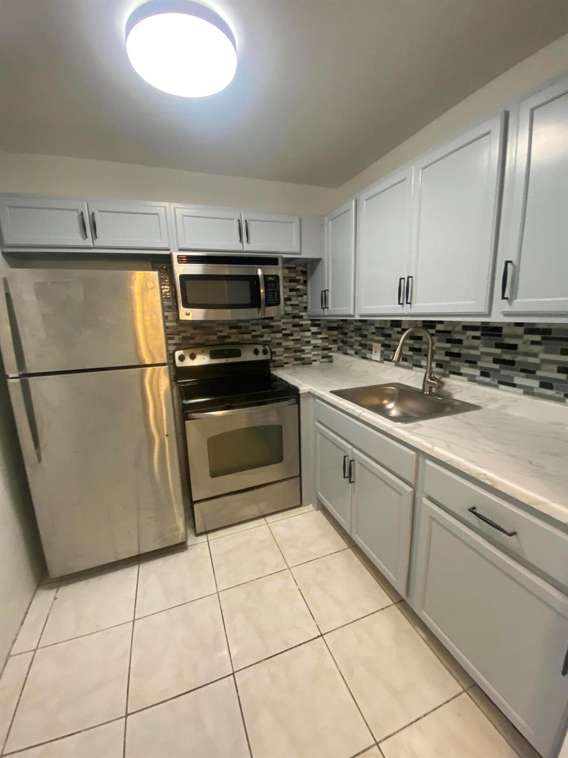 For rent in a 55 + adult retirement community a lovely 1 BD, 1 BA condo situated on the second floor. The condo is rented unfurnished, has new kitchen cabinets, ceramic tiles and nice sunroom with a garden view. Century Village has many amenities to offer to residents, like over a 1000 seat clubroom to watch shows and movies, indoor and outdoor pools, courtesy bus service, medical facilities, beauty shop, tennis, boating and more. Close proximity to PBI airport, restaurants, shops and beaches
