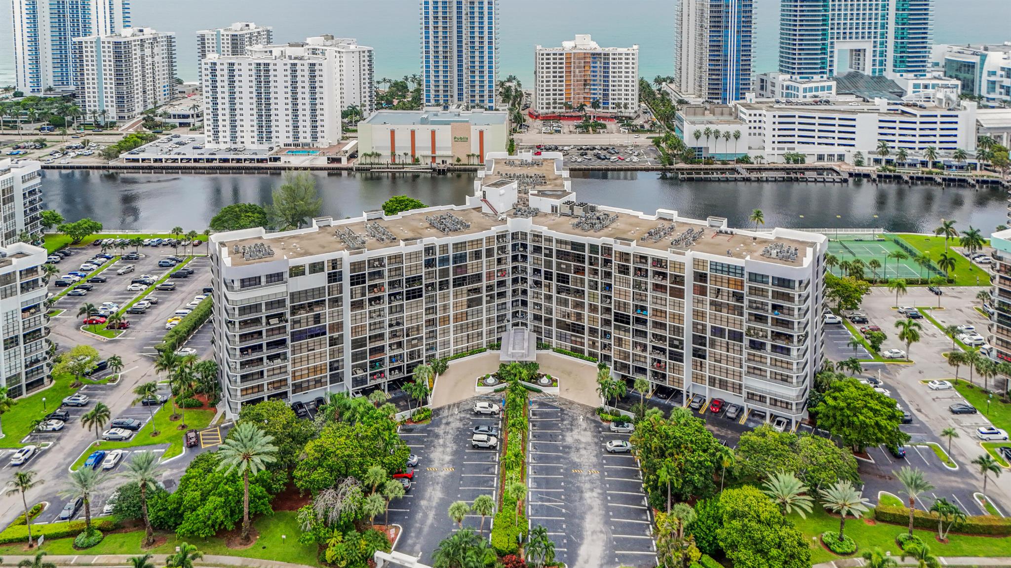 Enjoy direct intracoastal views from multiple rooms in this updated 1 bedroom, 2 bathroom unit. The residence features laminate flooring throughout, a modernized kitchen, updated baths, an in-unit washer and dryer, and a fully covered parking space located just steps from the ground floor entrance. The spacious primary bedroom includes a generously sized walk-in closet.  Option to easily convert the unit into a two-bedroom configuration (please refer to the attached floor plan). Both lobbies and all first-floor amenities (fitness rooms, card room, and meeting room) have undergone renovations. Residents also enjoy picturesque water views from the pool and tennis court areas. This location is close to the beach, Aventura Mall, Gulfstream Park and Casino, as well as a variety of restaurants.