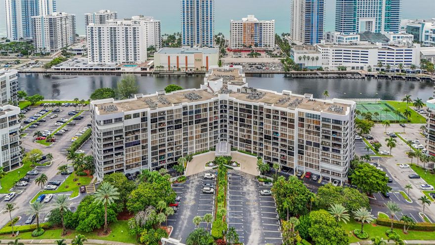 Enjoy direct intracoastal views from multiple rooms in this updated 1 bedroom, 2 bathroom unit. The residence features laminate flooring throughout, a modernized kitchen, updated baths, an in-unit washer and dryer, and a fully covered parking space located just steps from the ground floor entrance. The spacious primary bedroom includes a generously sized walk-in closet.  Option to easily convert the unit into a two-bedroom configuration (please refer to the attached floor plan). Both lobbies and all first-floor amenities (fitness rooms, card room, and meeting room) have undergone renovations. Residents also enjoy picturesque water views from the pool and tennis court areas. This location is close to the beach, Aventura Mall, Gulfstream Park and Casino, as well as a variety of restaurants.