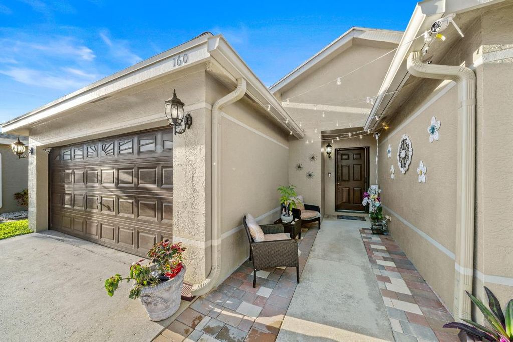 Photo of 160 Heatherwood Drive, Royal Palm Beach, FL 33411 (MLS # R10997383)