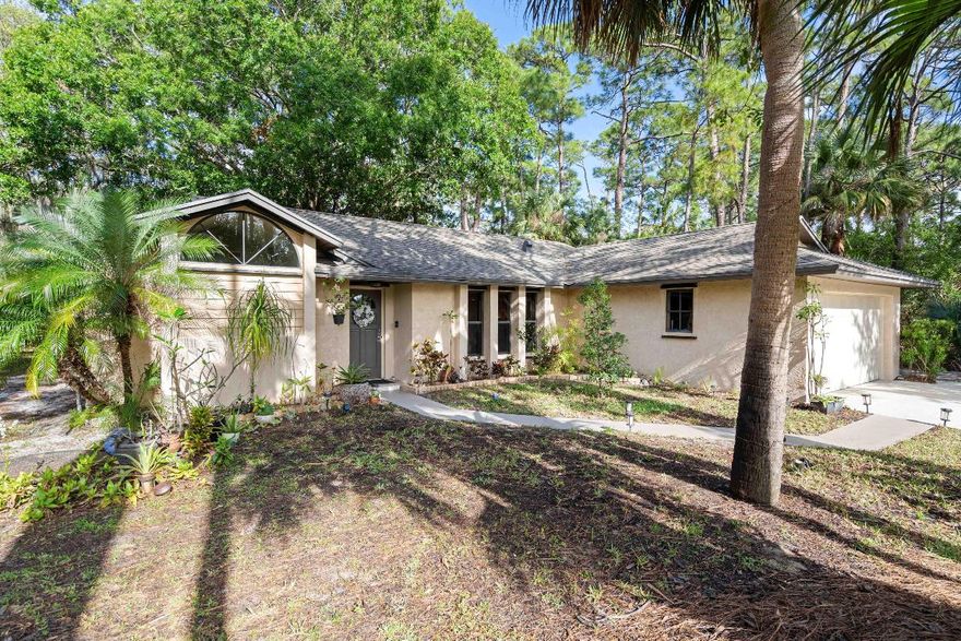 This 3-bed, 2-bath CBS home is tucked away in a serene oak hammock with a park-like setting that feels like country living, yet offers easy access to shopping, restaurants, and major freeways. The expansive backyard, shaded by majestic oak trees, provides a private retreat perfect for outdoor enjoyment. Relax on the screened back porch with a convenient kitchen pass-through window, ideal for entertaining. Inside, bright and spacious rooms flow seamlessly. Recent updates include a newer roof, A/C, & HWT.  New kitchen. French doors lead to large screened patio.  Beautiful Natural light flows through this home.   for added peace of mind. Underground power lines preserve the natural beauty and help keep this home safe.  making this a true city sanctuary.