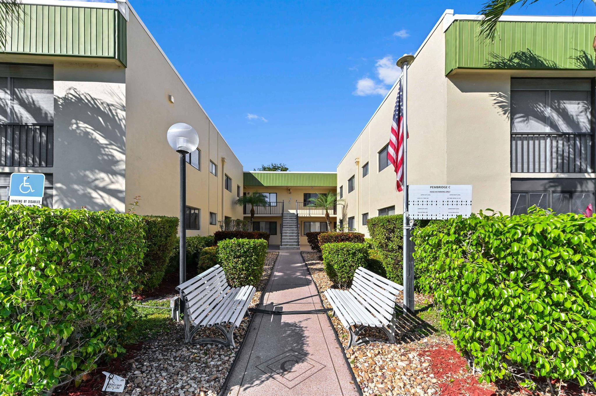 This exceptional condominium, situated in the sought-after Lakes of Delray community, offers a captivating experience of comfort and serenity. Commanding a tranquil garden view, both from the front and the patio, this property emanates an atmosphere of ease and well-being. As one approaches, a spacious, light-filled atmosphere greets the eye, which is the result of not only the strategic placement of windows and sliders, but also their impact/UV film that heightens both safety and energy efficiency. Further enhancing security, a hurricane shutter is carefully fitted on the living room window, with a secure wall safe located within the closet for peace of mind.