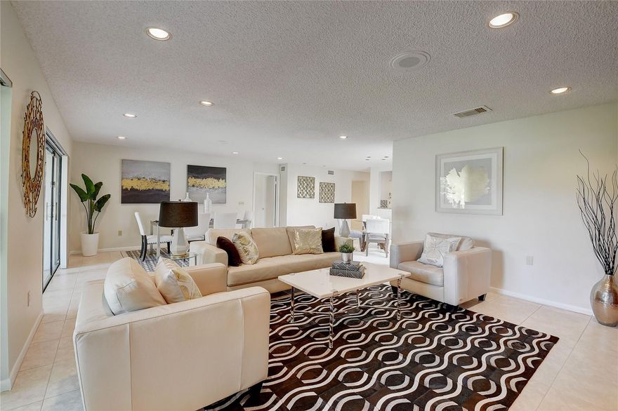 Boca Lago Golf & Country Club living with no mandatory membership! This 1st floor corner unit enjoys lake and private green area from a glass-enclosed sunroom providing lots of extra living space. Currently a 2 bed but Easy to convert into 3rd bed/den as per original plan. The kitchen and the bathrooms have been upgraded so there is little to do except move right in. Additional side patio for a comfortable Bar-B-Q and outdoor seating area along with a private storage outside storage area. Located in the newest part of Boca Lago, The Pines, you will enjoy a manned gated entrance. gatehouse, 2 beautiful pools, and a clubhouse in this gorgeously maintained and peaceful 55+ community. BocaLago offers optional amenities including golf, tennis, dining, an exercise room, and social membership
