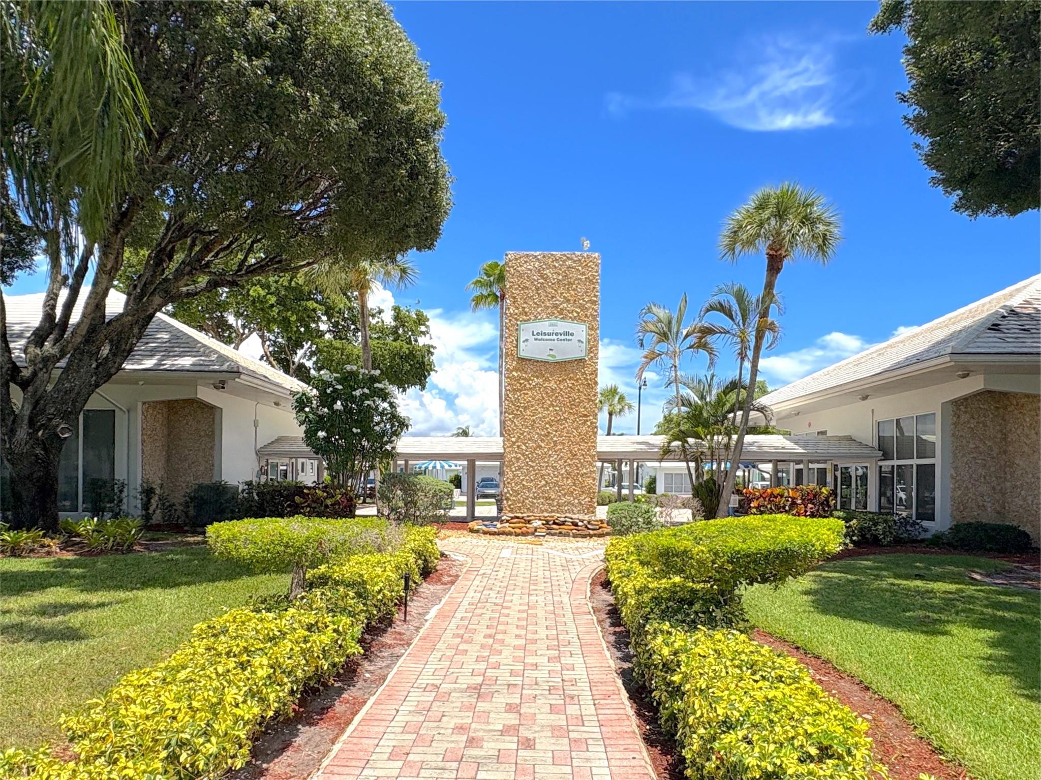 Do not miss this beautifully maintained 2BR/1BA 2nd-floor condo with stunning golf course and lake views from the glass-enclosed Florida room with accordion shutters. Freshly painted, tastefully furnished, and offered turnkey (or unfurnished). Features include an updated kitchen with stainless steel appliances (2017), hurricane windows, laminate/tile floors, king bed with walk-in closet in master, new queen mattress in guest room, water heater (2017), AC (2021), and roof (2015). Community offers 2 pools, shuffleboard, petanque, and BBQ areas. Minutes to shops, dining, and beaches.