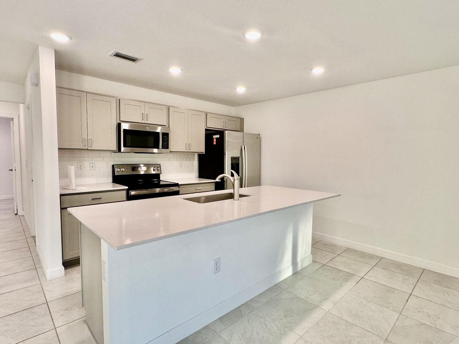 Welcome to this stunning 4 bedrooms / 2.5 bathrooms Two-Story Corner Townhome in Lakewood Cove. Very modern, and spacious built in 2023, perfectly designed for comfortable family living, boasts contemporary features:Modern Kitchen: Wood cabinetry, luxury quartz countertops, and stainless-steel appliances with open floor plan: Spacious kitchen flows into the dining and family room, perfect for entertaining Hurricane-resistant windows and doorsGarage & Storage. and offers convenient access to I-95, the Turnpike, beaches, and shopping centers.