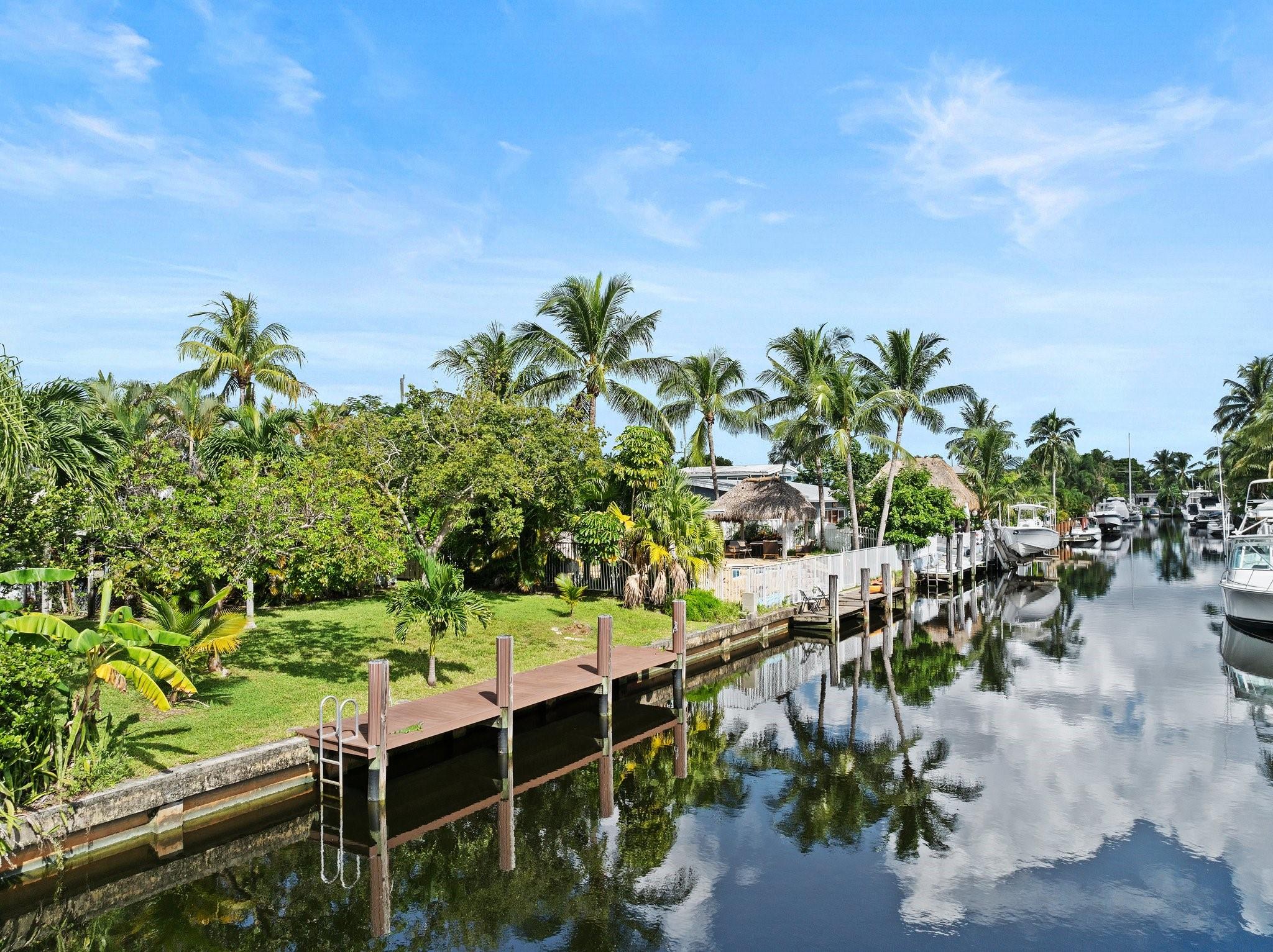 Unbeatable price for waterfront living! Uncover the potential of this 2-bdrm, 1 bath charming home in Lauderdale Isles, a vibrant boating community. This well-maintained waterfront home is a blank canvas for customization. It features 65’ on the ocean access canal, a 2017 composite dock, brand new refrigerator, new range, open-beam & vaulted ceilings, a large storage shed & more. Whether you’re envisioning your forever home or a lucrative investment, this property offers many possibilities. Enjoy the community boat ramp nearby, along with easy access to local schools, parks & major highways. Enjoy serene water views, easy access to the ocean, & the tranquility of a waterfront lifestyle. Don’t miss out on this lovely opportunity!