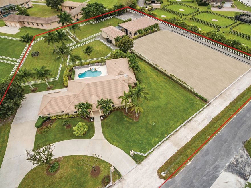 Short hacking distance to WEF and on the horse show side of Greenbriar Blvd., this lovely property has plenty of room for riders, barn mates and staff. The farm is complete with a separate entrance to an 8 stall barn, 3 wash stalls, sand ring, 3 grassy paddocks, and a 2br/1ba barn apartment w/full kitchen. There is also a separate Hay, Feed & Tack room with laundry inside. As you walk into the main house there is an open feeling from the volume ceilings and rear glass impact sliders that lead out to the covered patio and spa/pool deck. The kitchen, bathrooms and laundry room all boast granite countertops and upgrades like custom cabinets and stainless steal appliances in the kitchen. There are  amenities like a split bedroom layout, fire place, central vac, cabana bath and outdoor shower.