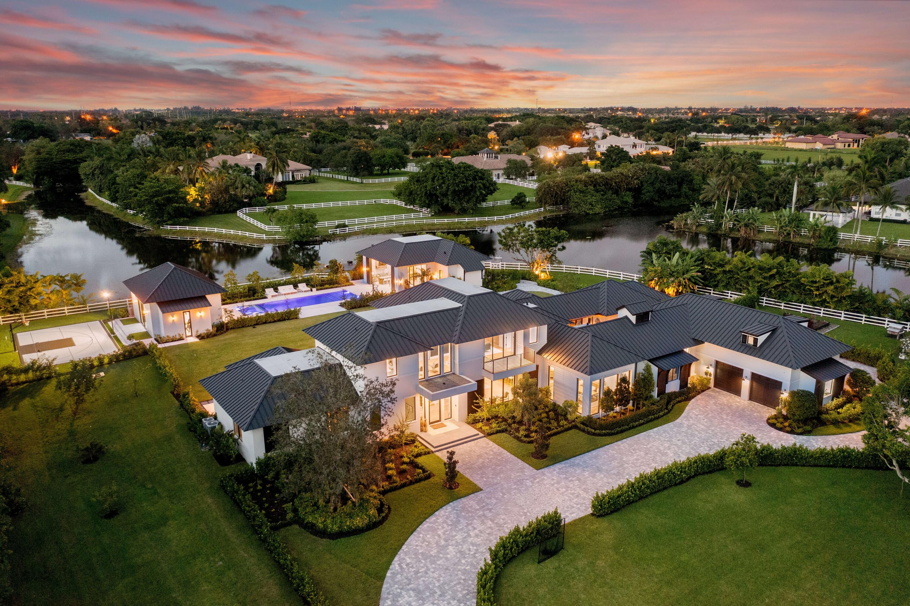 Mi Tierra Delray Beach is an impeccable new contemporary estate offering rich organic design set on nearly 3 acres of idyllic lakefront property. This custom multidimensional compound is situated behind private gates of Tierra Del Rey, an exclusive and sought-after community in Palm Beach County. The waterfront estate consists of three distinct structures offering the utmost in privacy and modern family lifestyle. It encompasses 10,099 square feet of living space and 12,973 square feet in total. The property features finest materials, craftsmanship and sophisticated organic design and neutral hues.