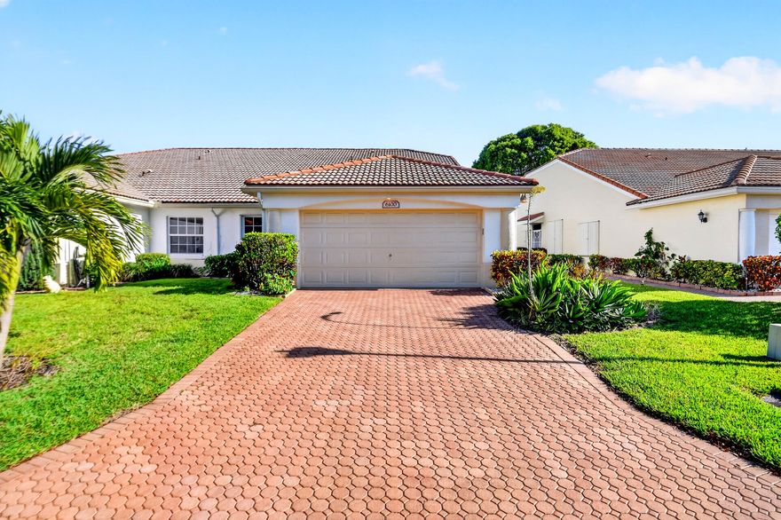 Enjoy lake views and a spacious layout in this beautifully maintained 3BR/2BA corner villa (Jasmine Model) located in the gated 55+ community of Floral Lakes. This light-filled home features ceramic tile floors, high ceilings, an enclosed lanai for added living space, and a desirable split-bedroom floor plan. The eat-in kitchen offers 42-inch cabinets, new stainless steel appliances, and plenty of room for casual dining. The oversized primary suite includes dual sinks, separate tub and shower, whirlpool spa, and walk-in closet. Additional highlights include a den/office, full-size interior laundry room, storm shutters, and a 2-car garage. Floral Lakes offers an active lifestyle with clubhouse, pool, fitness center, tennis, pickleball, billiards, library, media room, and more.