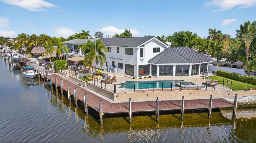 Rare point lot with almost 200 feet of waterfront and dock less than two miles from the beach! Discover stunning vistas and captivating sunsets from this meticulously renovated home. The residence includes 4 BRs and 3.5 baths, with one BR designed as an entry-level mother-in-law suite featuring private entrance and full bath. Upstairs features a huge master bedroom suite, all BRs with water views and a loft area. The kitchen features all new Viking appliances and a convenient pass-through window to the outdoor bar. Additional highlights include three new AC units, new impact windows, luxury front door, heated pool, security system, standing seam metal roof, and a two-car garage with a workstation and epoxy flooring. Only one fixed bridge between you and the ocean! More details to come