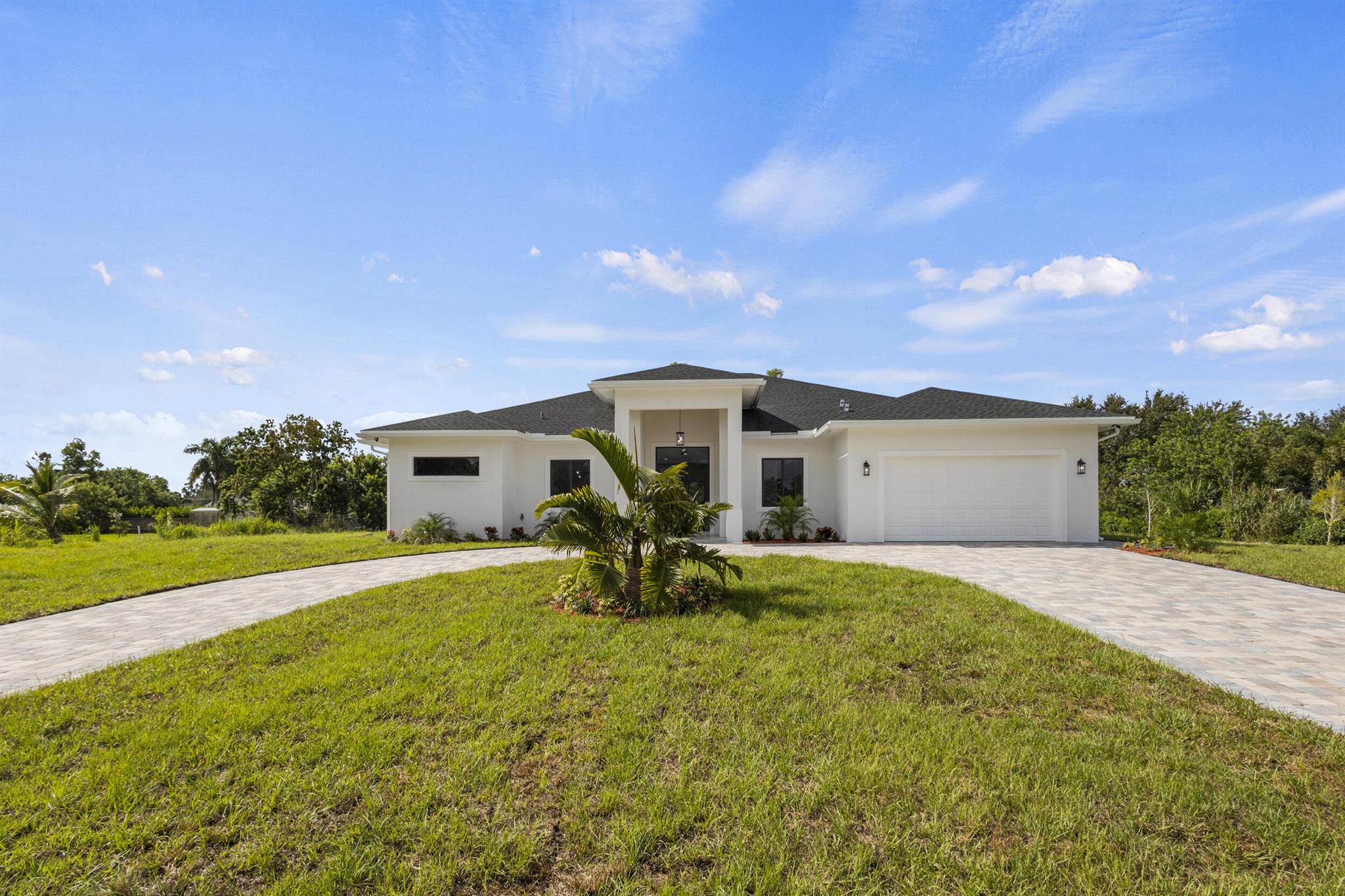 Brand-new CBS home with a two-car garage on 1.15 acres in the heart of Loxahatchee! This 4-bedroom, 3.5-bathroom residence features an open, modern layout with vaulted ceilings, porcelain tile flooring, and impact-rated doors and windows.The gourmet kitchen boasts wood cabinetry, quartz countertops, a large island, oversized pantry, and brand-new stainless steel appliances. The luxurious master suite includes a Roman tub, separate shower, dual vanities, and his-and-her walk-in closets with custom-built shelving.The expansive lot provides exceptional versatility -- allowing you to bring in your boat, RV, trailer, or trucks, raise animals such as horses, or even build a guest house, workshop, or large structure. The backyard is extremely spacious, providing plenty of room for a