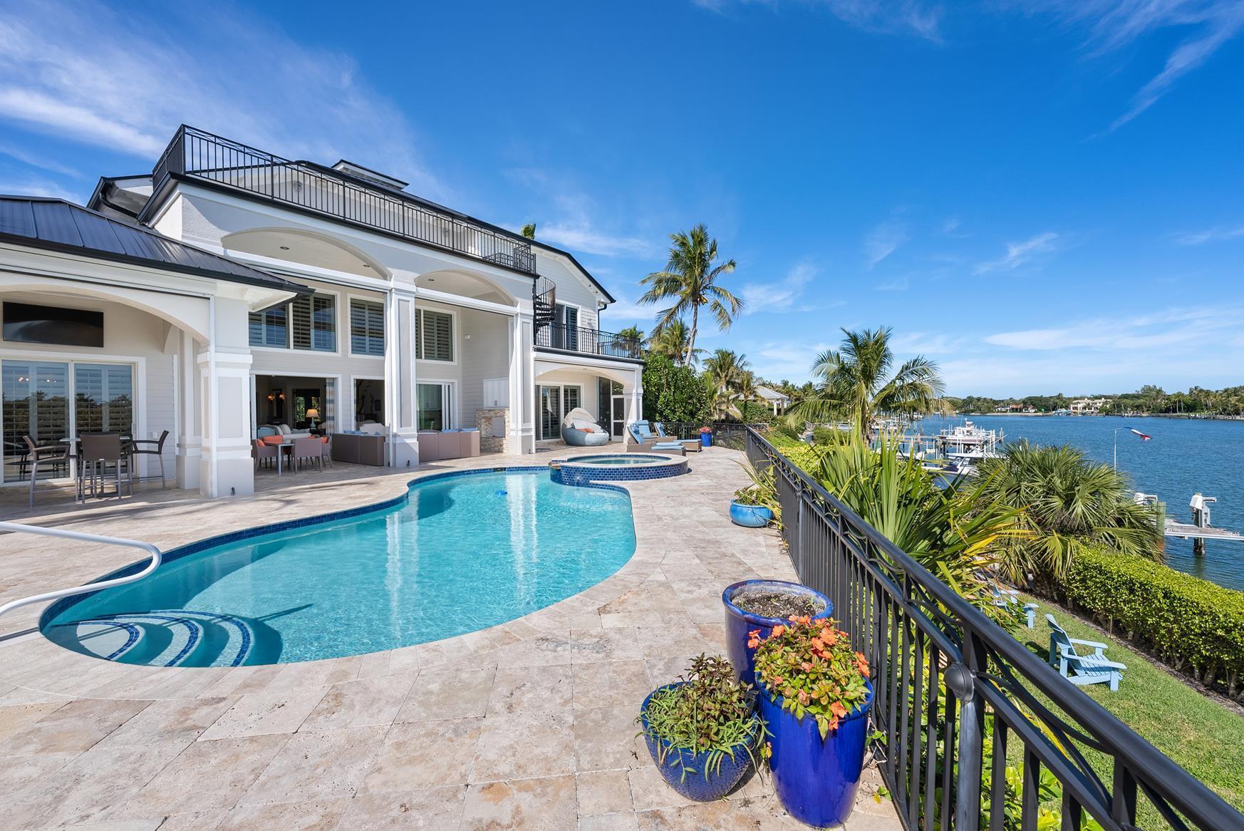Welcome to the highly desirable, RARELY available, waterfront community of Indian Hills, where you can wake up to the soothing sound of ocean waves as you enjoy your expansive intracoastal waterway views. Enjoy the turquoise blue water both to the north and south, while overlooking 100+ feet of waterfrontage, including a 70 ft dock, boasting 2 10k lb lifts. 2023 aluminum roof with 30 yr warranty. Wolf Appliances. New Ac's, new exterior paint. New tankless H2O heater, 1st floor Master Suite w/3 guest suites upstairs, each with full bath. NO HOA. 10 mins from lowering the boat in the water you are running out of the famed Jupiter Inet, or 2 mins. from the sandbars. World class golf - Medalist, Mcarther, Bears Club, Old Marsh, Jupiter HIlls, Apogee, Discovery all within minutes.