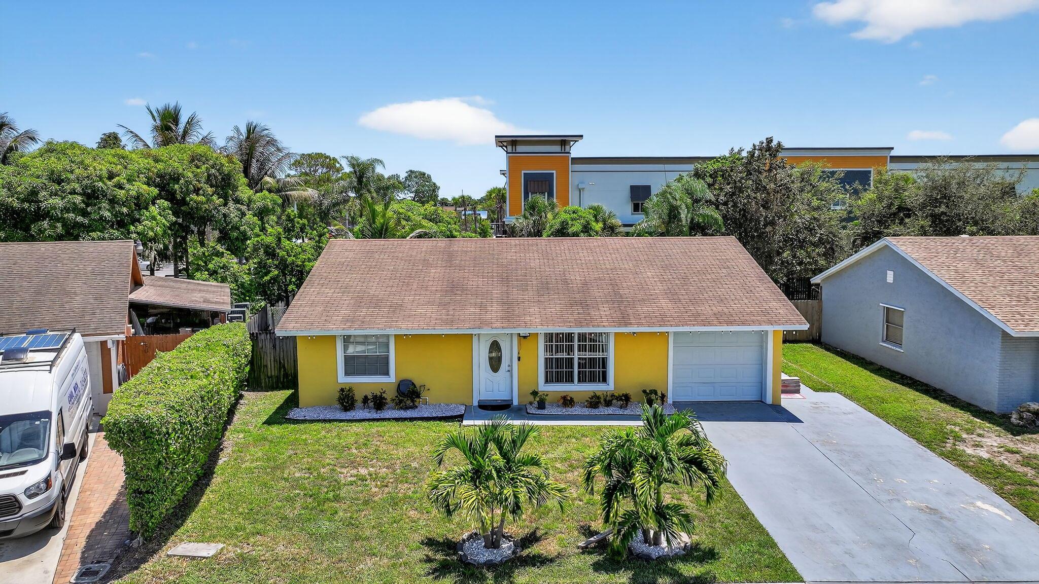 Welcome to this charming 3 bedroom, 2 bath home located in the desirable Concept Homes community of Lantana. Featuring an updated kitchen (2018) with custom cabinetry stainless steel appliances, and a stylish glass tile backsplash. The spacious open floor plan is highlighted by 2 stone facade accent walls and includes a 12 x 14 bonus room, perfect for a home office, playroom or den. Outside enjoy a fully fenced in yard with mature fruit trees including mango, avocado, coconut, and cahiman- your own private tropical retreat. A new roof was installed in 2018, giving peace of mind for years to come. Conveniently located just off !-95, this home is only 10 minutes from the beach, with plenty of shopping and dining near bye as well.