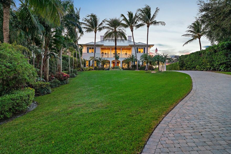 Experience year round ocean breezes in this British West Indies inspired 4 BR, 4.1 BA CBS residence perfectly positioned 24 feet above sea level across from the Intracoastal Waterway and set on a 3/4 acre lot.  An extensive renovation completed in 2022 features porcelain flooring, high-end cabinetry, quartz countertops, Thermador appliances, and a newly built resort style pool.   Entertain effortlessly in the gourmet kitchen, dining area with the convenience of a butler's pantry, and spacious living room, or unwind in the media room and guest suite overlooking the pool. Upstairs, the primary suite is a serene retreat with east and west facing balconies for sunrise and sunset views and two walk in closets. The 2nd floor also includes a private office and two additional en suite bedrooms. Plans are available to accommodate a future elevator should the need arise, offering flexibility for long-term living. This home is further enhanced by a whole home generator, new standing seam metal roof (2022) and a 3 car climate-controlled garage. Intracoastal access for fishing, paddle boarding and kayaking. Located in the prestigious Indian Hills neighborhood directly across from Jupiter Hills Golf Club, and just a short drive to other world class golf destinations including The Medalist, McArthur and Apogee.  Also, near the pristine beaches of Jupiter Island, as well as fine dining and upscale shopping-and only 30 minutes from both PBI and Witham Field. This home combines elegance, privacy and an unbeatable location-Florida living at its finest!